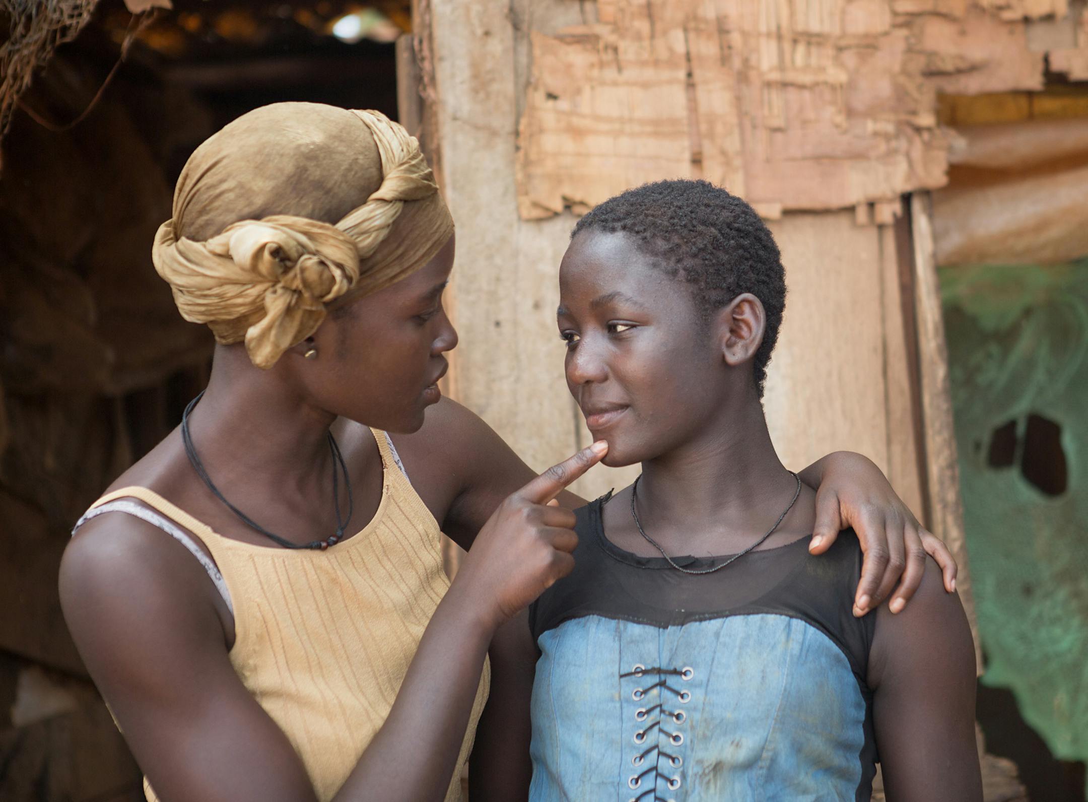 In this image released by Disney, Lupita Nyong'o, left, and Madina Nalwanga appear in a scene from "Queen of Katwe." (Edward Echwalu/Disney via AP)