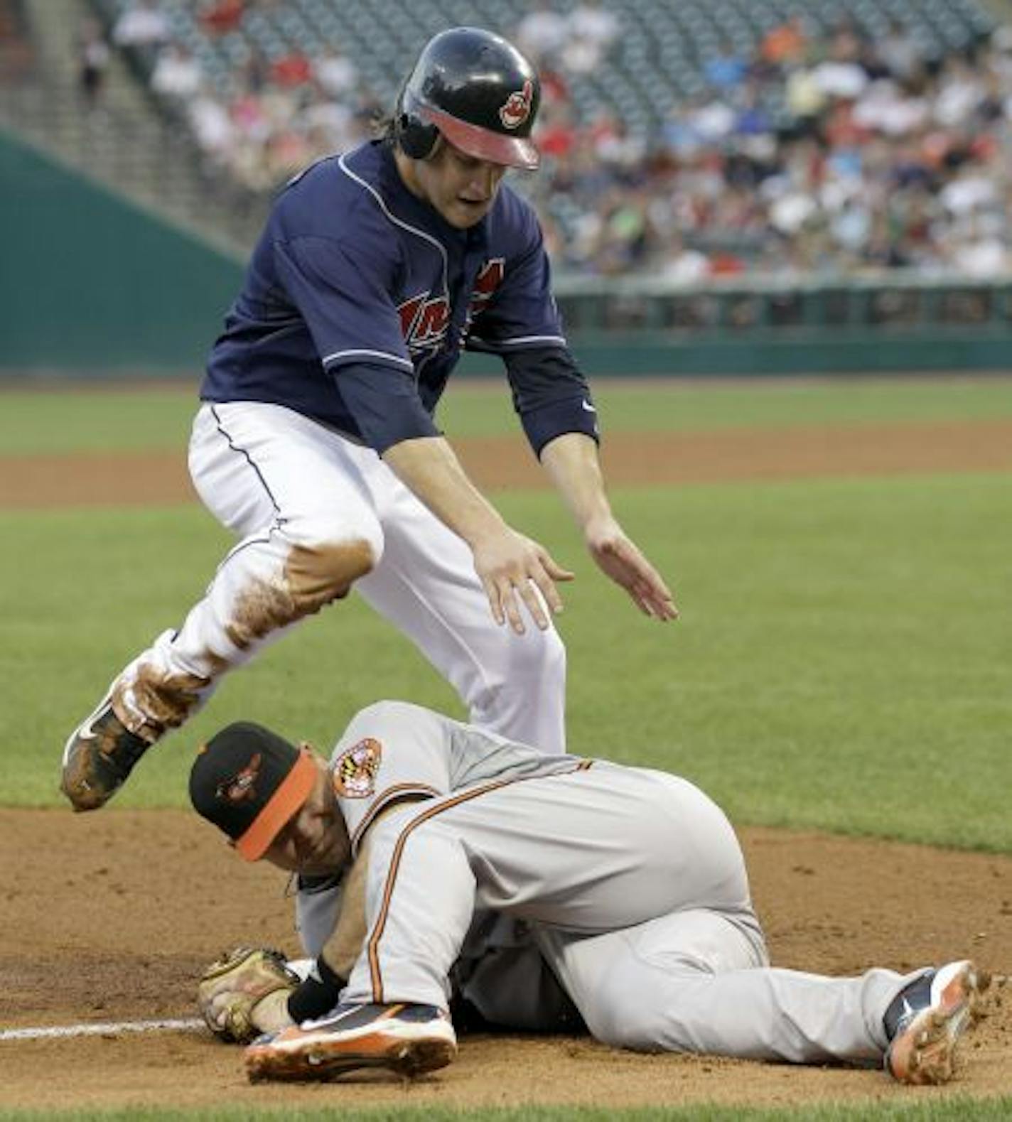 Cleveland Indians' Trevor Crowe steals third, beating the tag by Baltimore Orioles third baseman Ty Wigginton in the fourth inning of a baseball game in Cleveland on Tuesday, Aug. 10, 2010.