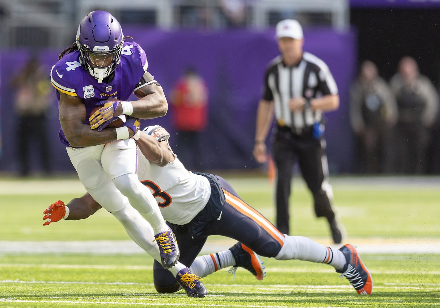 Vikings running back Dalvin Cook (4) runs for a first down despite defensive pressure from Bears linebacker Nicholas Morrow (53) in the first quarter US Bank Stadium in Minneapolis, Minn., on Sunday, Oct. 09, 2022. Vikings vs. Bears ] Elizabeth Flores • liz.flores@startribune.com