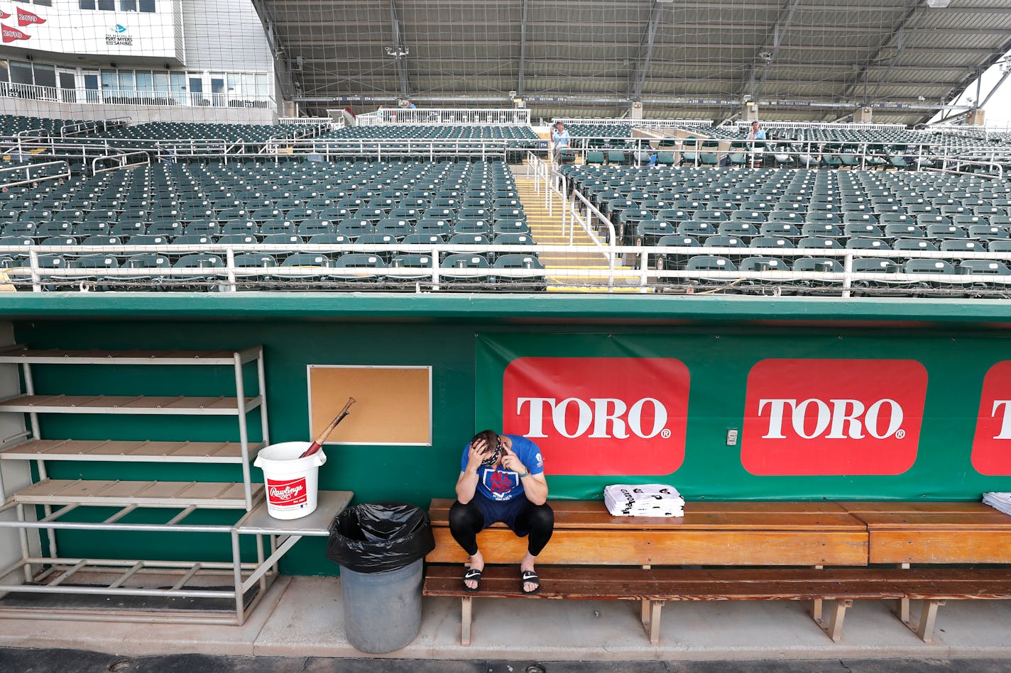 Twins catcher Mitch Garver talks on his phone in an empty Hammond Stadium on Thursday in Fort Myers. Major League Baseball has suspended the rest of its spring training game schedule because of the coronavirus outbreak.