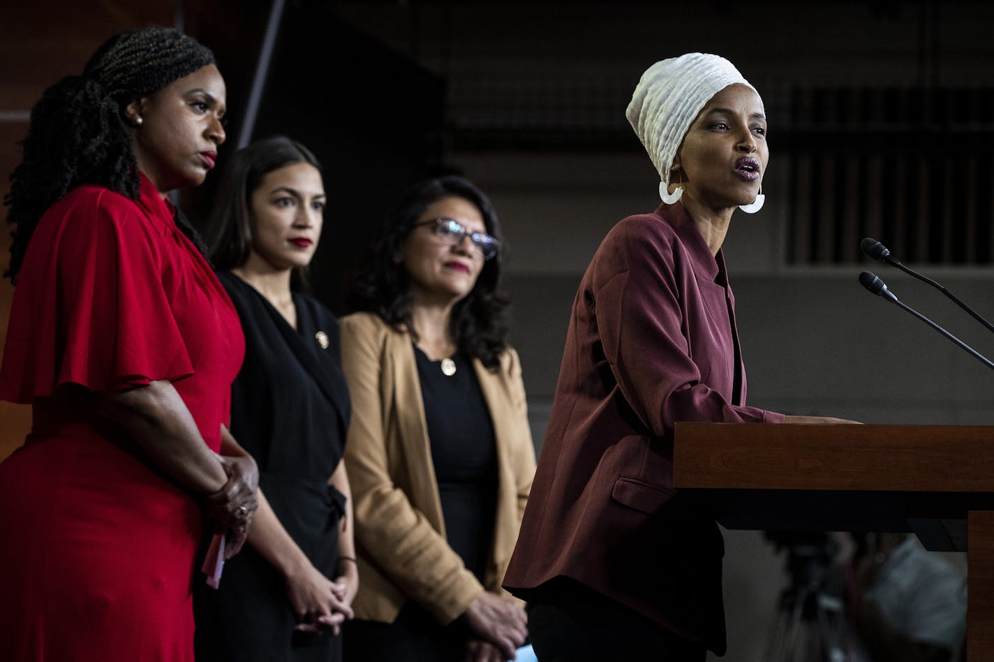 U.S. Reps. Ayanna Pressley, Alexandria Ocasio-Cortez and Rashida Tlaib listened as Rep. Ilhan Omar responded to remarks by President Donald Trump after his call for the four Democratic congresswomen to go back to their "broken" countries.
Reps. Ayanna Pressley (D-Mass.), Alexandria Ocasio-Cortez (D-N.Y.) and Rashida Tlaib (D-Mich.) listen as Ilhan Omar (D-Minn.) speaks at a news conference on Capitol Hill in Washington, July 15, 2019. President Donald Trump, under fire for comments he made about