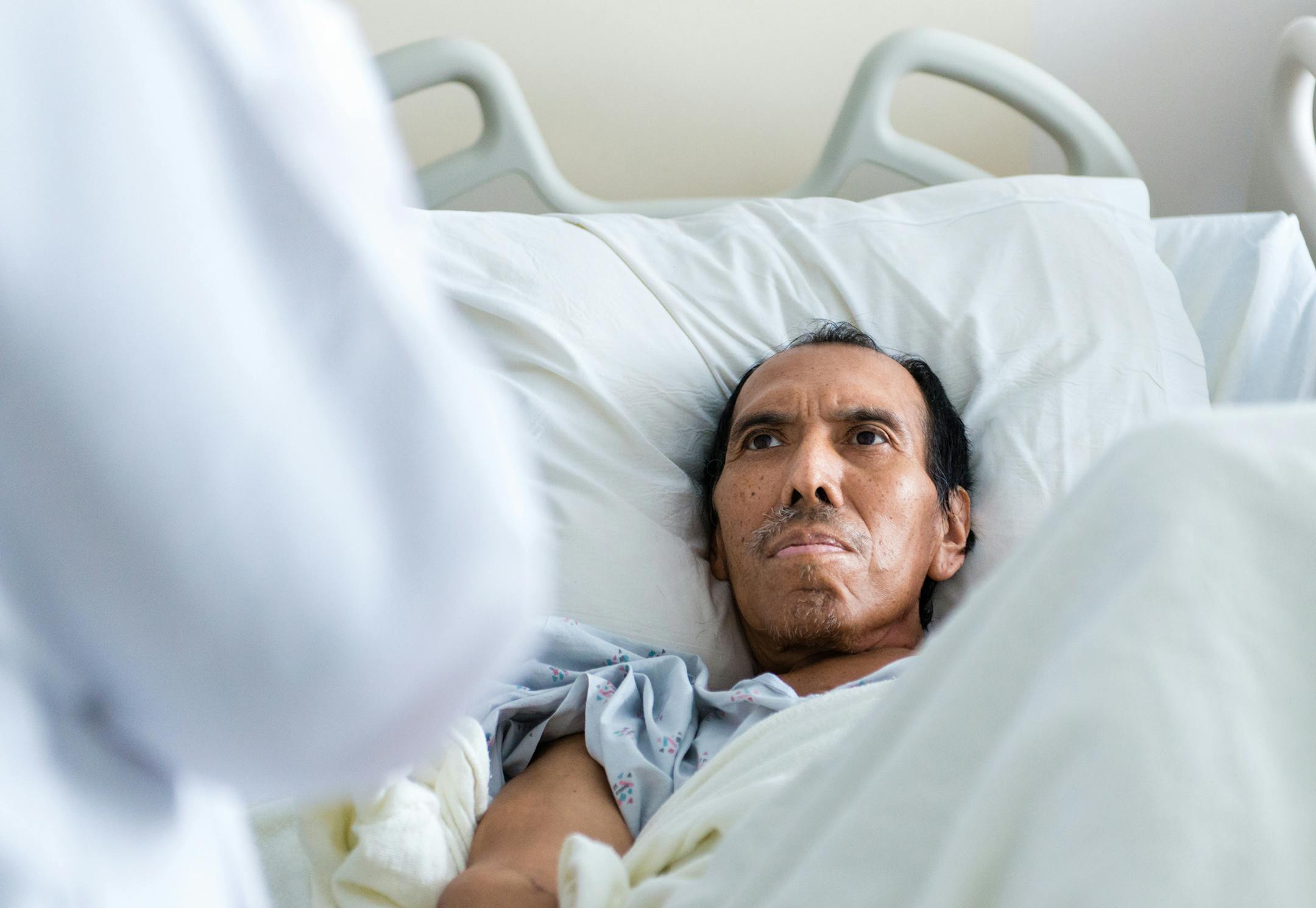 Jose Garcia Flores, 60, listens to Dr. Carin van Zyl as she explains that chemotherapy might not be an option to treat his colon cancer on Oct. 13, 2015. (Heidi de Marco/Kaiser Health News/TNS) ORG XMIT: 1177758