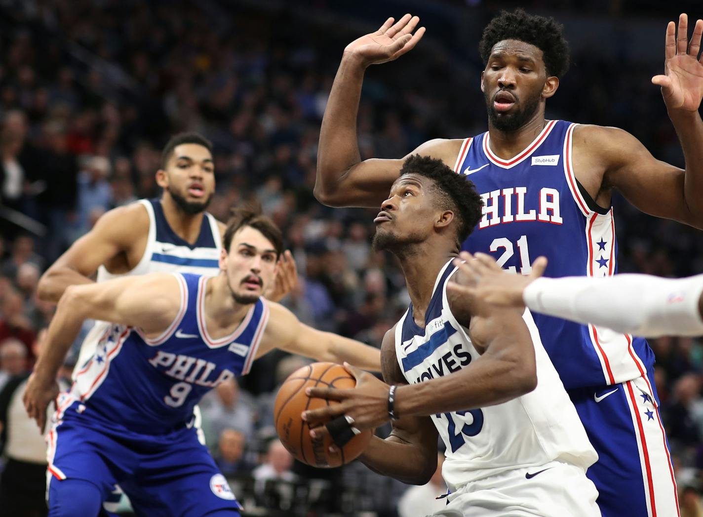 Minnesota Timberwolves guard Jimmy Butler (23) scored over Philadelphia 76ers center Joel Embiid (21) in the second half during NBA action at Target Center Tuesday December 12, 2017 in Minneapolis, MN.] The Minnesota Timberwolves hosted the Philadelphia 76ers at Target Center. JERRY HOLT &#xef; jerry.holt@startribune.com