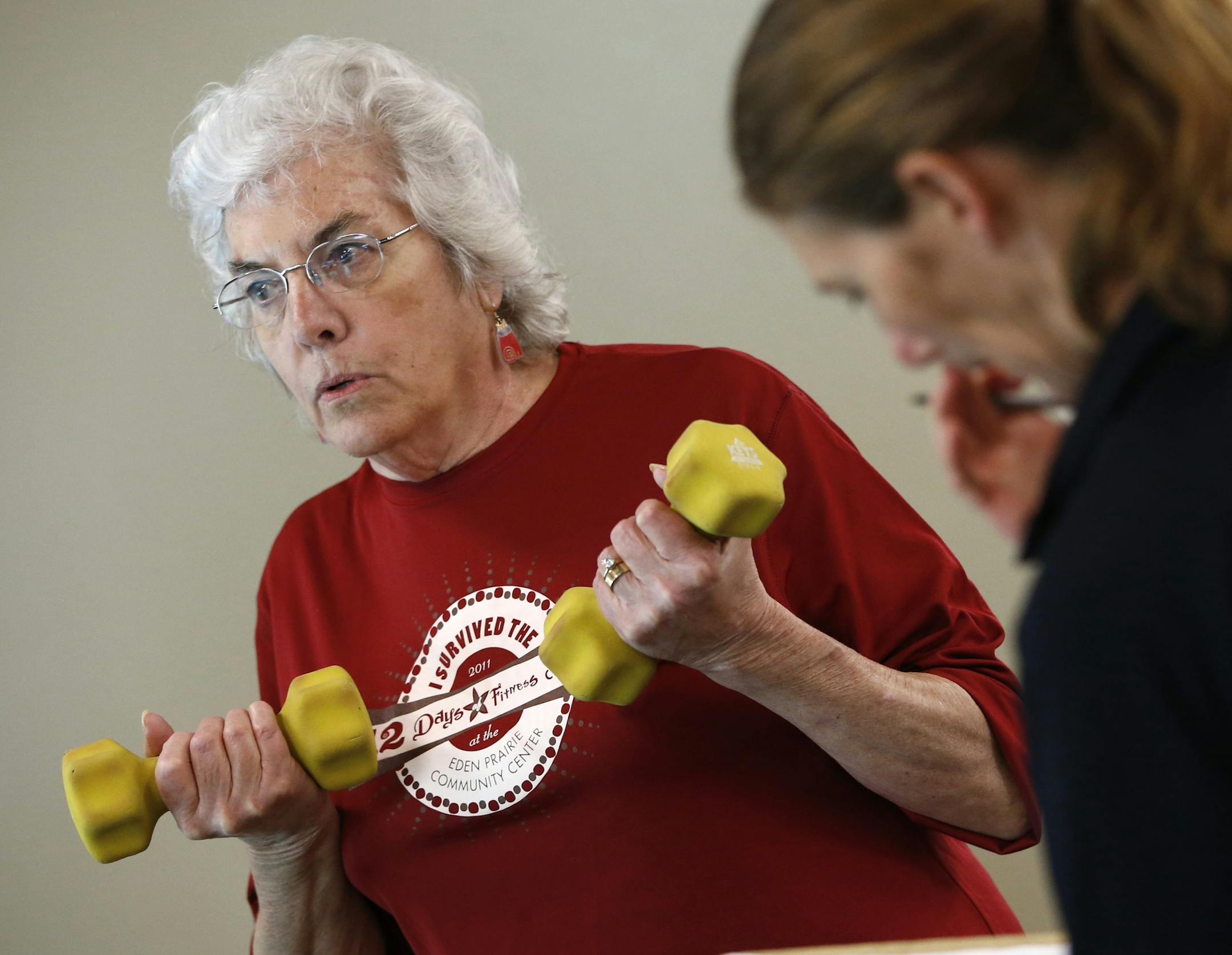 (left to right) Diana Hambrook, of Eden Prairie progress on the weights was tracked by Kara Jeter, cancer fitness class trainer, during the fitness program for cancer survivors at the Eden Prairie Community Center on 5/23/13.] Bruce Bisping/Star Tribune bbisping@startribune.com Diana Hambrook, Kara Jeter/source.