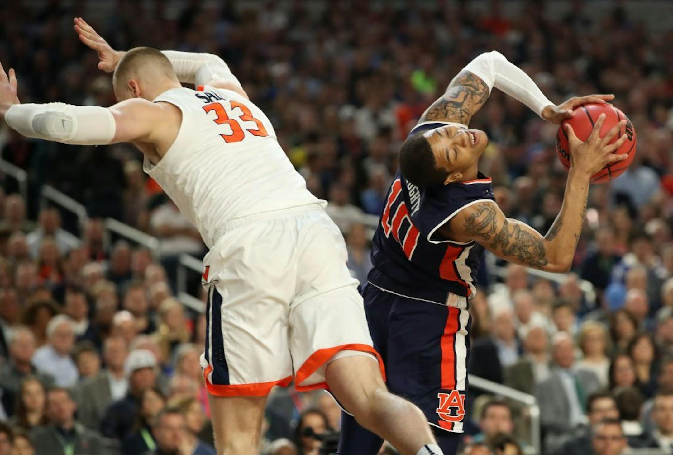 Virginia Cavaliers center Jack Salt (33) fouled Auburn guard Samir Doughty (10) during the first half.