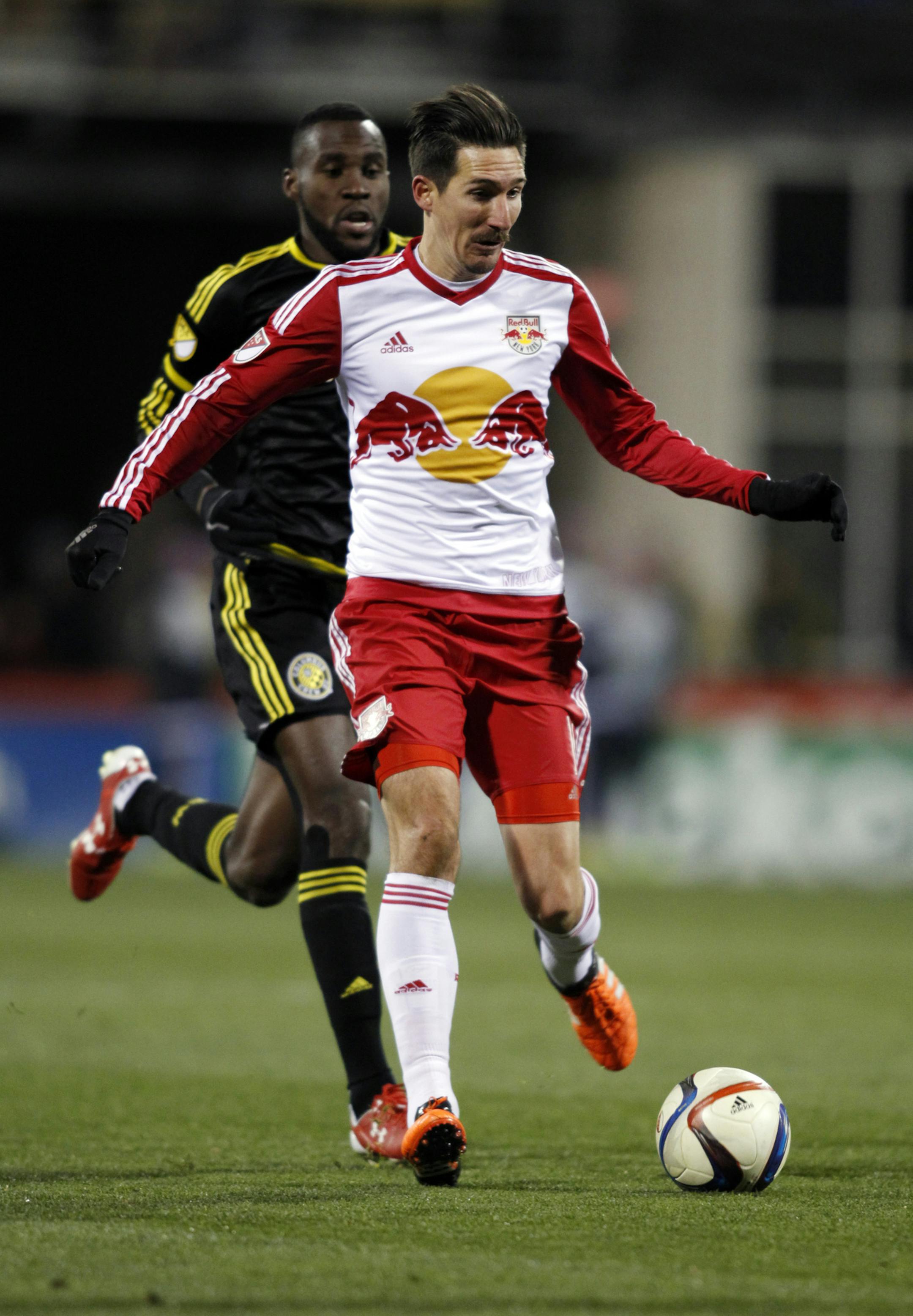 New York Red Bulls midfielder Sacha Kljestan, right, works for the ball against Columbus Crew midfielder Tony Tchani during the second half in the first leg of the MLS soccer Eastern Conference championship in Columbus, Ohio, Sunday, Nov. 22, 2015. (AP Photo/Paul Vernon) ORG XMIT: OHPV113