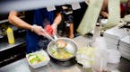FILE -- A cook plates fresh food at a restaurant in Queens, on Nov. 20, 2017. Amid a severe labor shortage and a renewed U.S. crackdown on undocumente