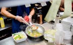 FILE -- A cook plates fresh food at a restaurant in Queens, on Nov. 20, 2017. Amid a severe labor shortage and a renewed U.S. crackdown on undocumente