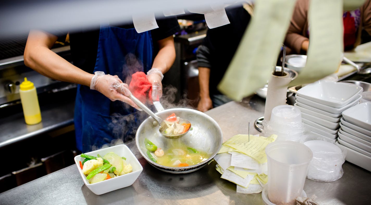 FILE -- A cook plates fresh food at a restaurant in Queens, on Nov. 20, 2017. Amid a severe labor shortage and a renewed U.S. crackdown on undocumented immigrants, restaurant owners are facing a choice: fire workers or risk prosecution. (Stephen Speranza/The New York Times)