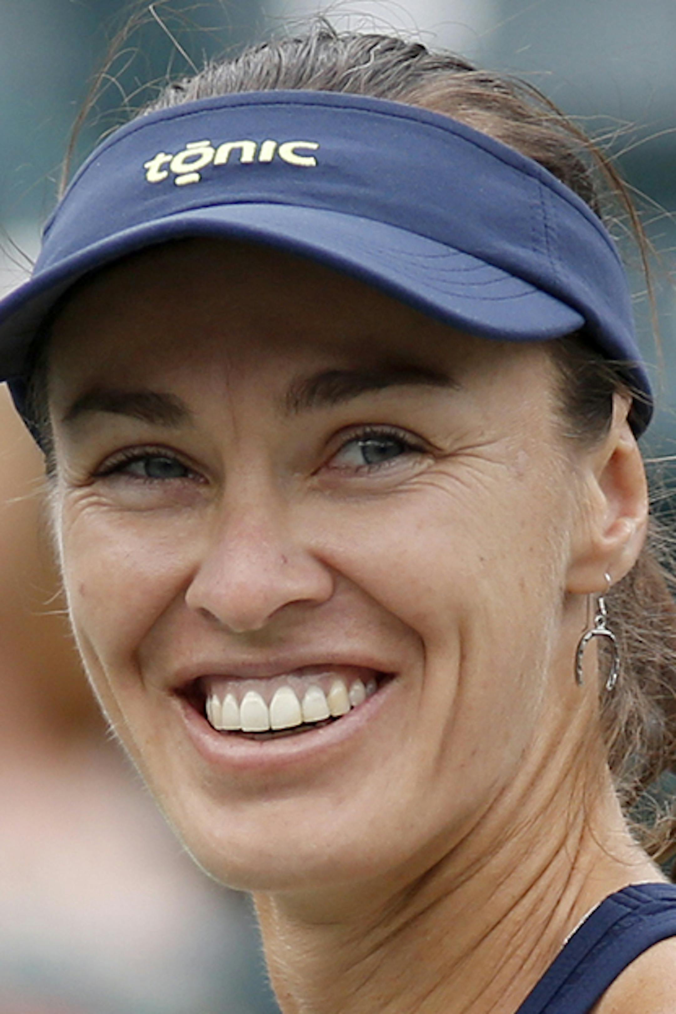 Martina Hingis, of Switzerland, looks at her coaches after defeating Alla Kudryavtseva and Anastasia Pavlyuchenkova during a doubles final match at the Family Circle Cup tennis tournament Sunday, April 12, 2015, in Charleston, S.C. Hingis and Sania Mirza, of India, won 6-0, 6-4. (AP Photo/Mic Smith) ORG XMIT: SCMS108