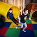 Leo Kuhl, with his friend Elliot Budziak, hop off the indoor slide, which travels from the upstairs mudroom down to the basement.