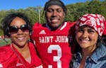 Ravi Alston, a St. John’s star as receiver Saturday, with mom Tyrisa & girlfriend Kiana Reedy on the field after Saturday’s game.