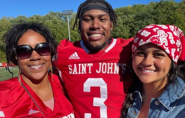 Ravi Alston, a St. John’s star as receiver Saturday, with mom Tyrisa & girlfriend Kiana Reedy on the field after Saturday’s game.