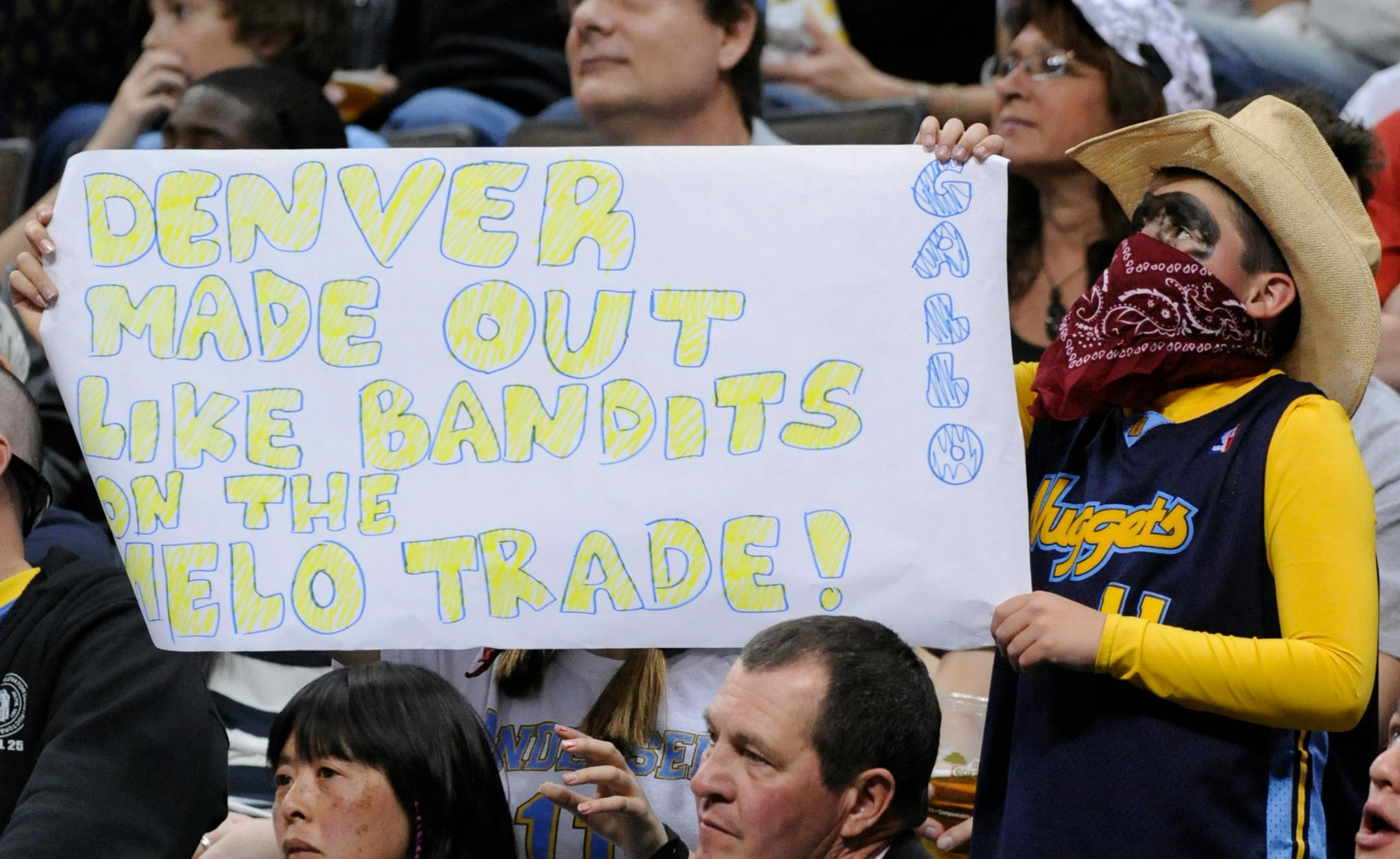 A Denver Nuggets fan holds a sign displaying his happiness with the trade of Carmelo Anthony, during the second quarter of the Nuggets' 130-106 win over the Minnesota Timberwolves in an NBA basketball game Saturday, April 9, 2011, in Denver. (AP Photo/Jack Dempsey)