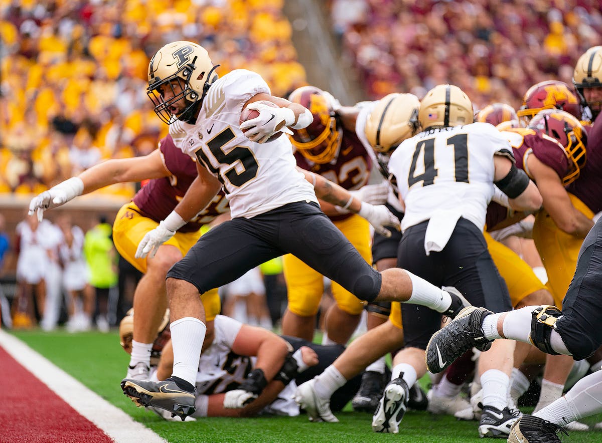 Purdue Boilermakers running back Devin Mockobee (45) scores a rushing touchdown against the Minnesota Gophers to put his team up by ten points in the 