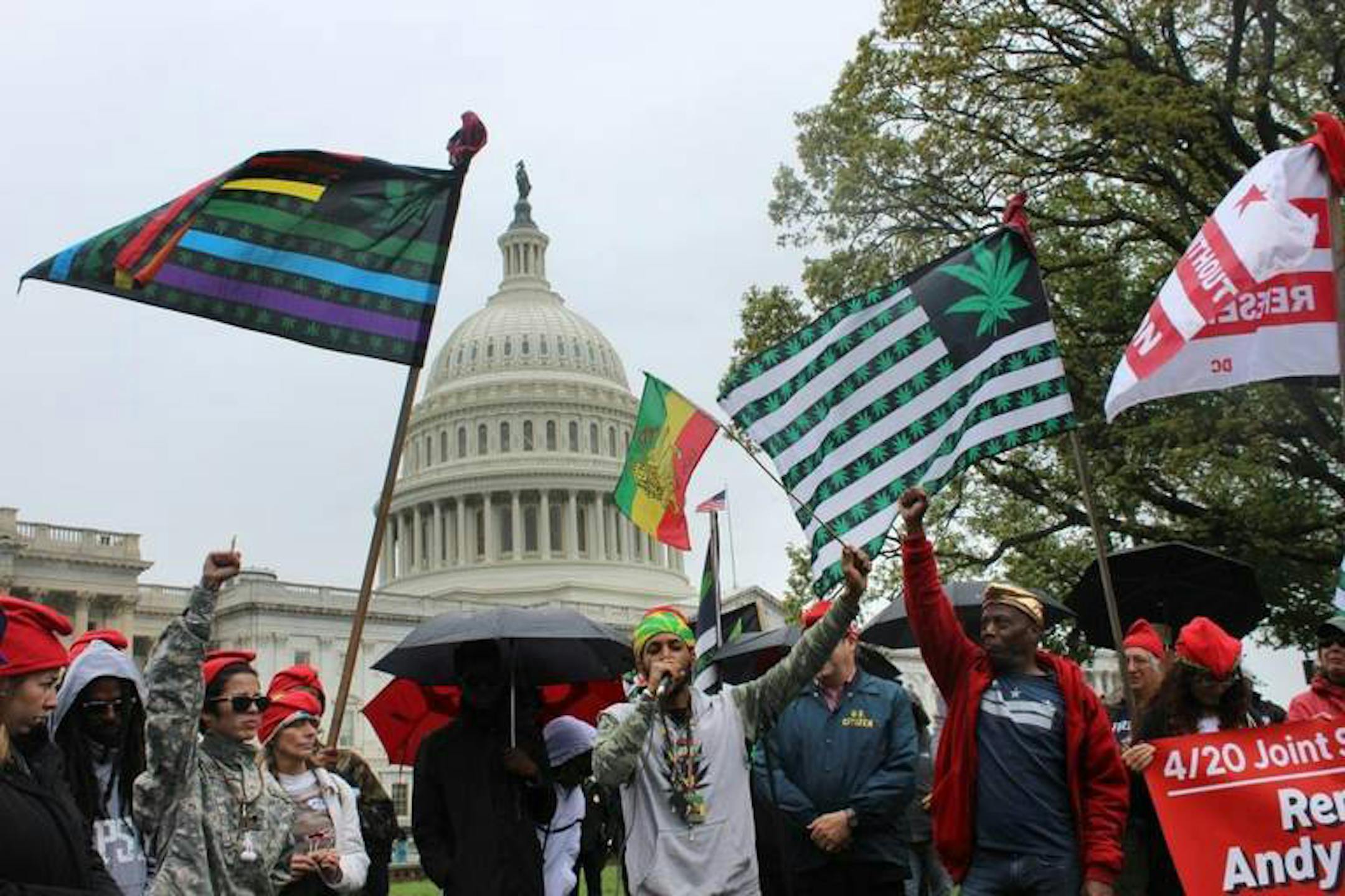 "Cannabis is peace; cannabis is love. We are here to spread peace; we are here to spread love. These are clouds of peace and clouds of love," says Ras Fia, center, holding a Rastafarian sign in front of the U.S. Capitol in Washington seconds before police arrested him for lighting a marijuana joint, on Monday, April 24, 2017. (Josh Magness/McClatchy/TNS) ORG XMIT: 1201212