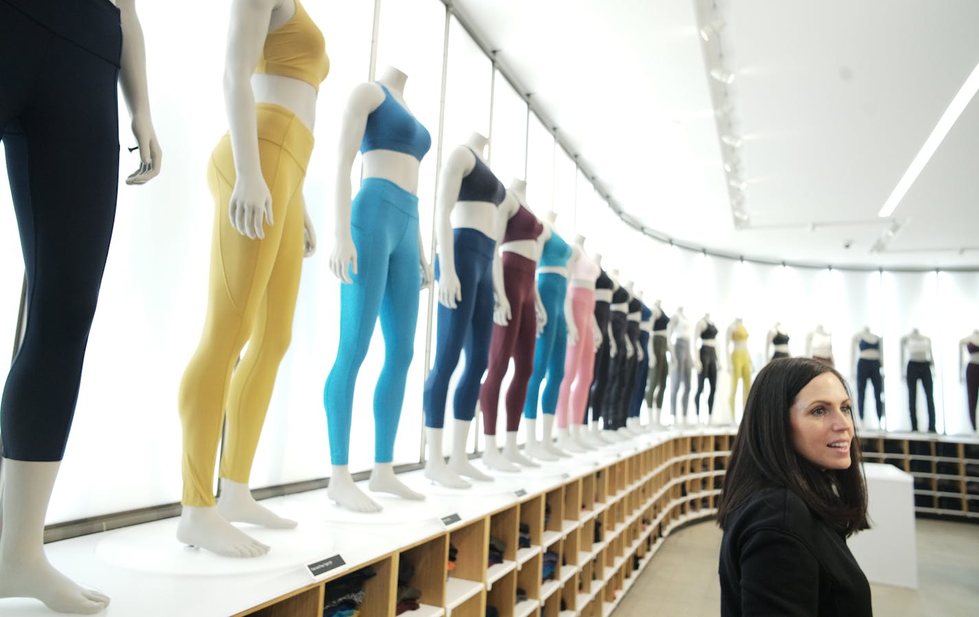 Maureen Erickson, a Lululemon executive, shows off some of the colors available as modeled on full-body mannequins. Lululemon opens a new store at the Mall of America Wednesday, one with a studio, lockers and a place to eat.