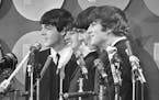 FILE - The Beatles address the media in the press room of Kennedy International Airport on their arrival, Feb. 7, 1964 in New York.  The Beatles are g