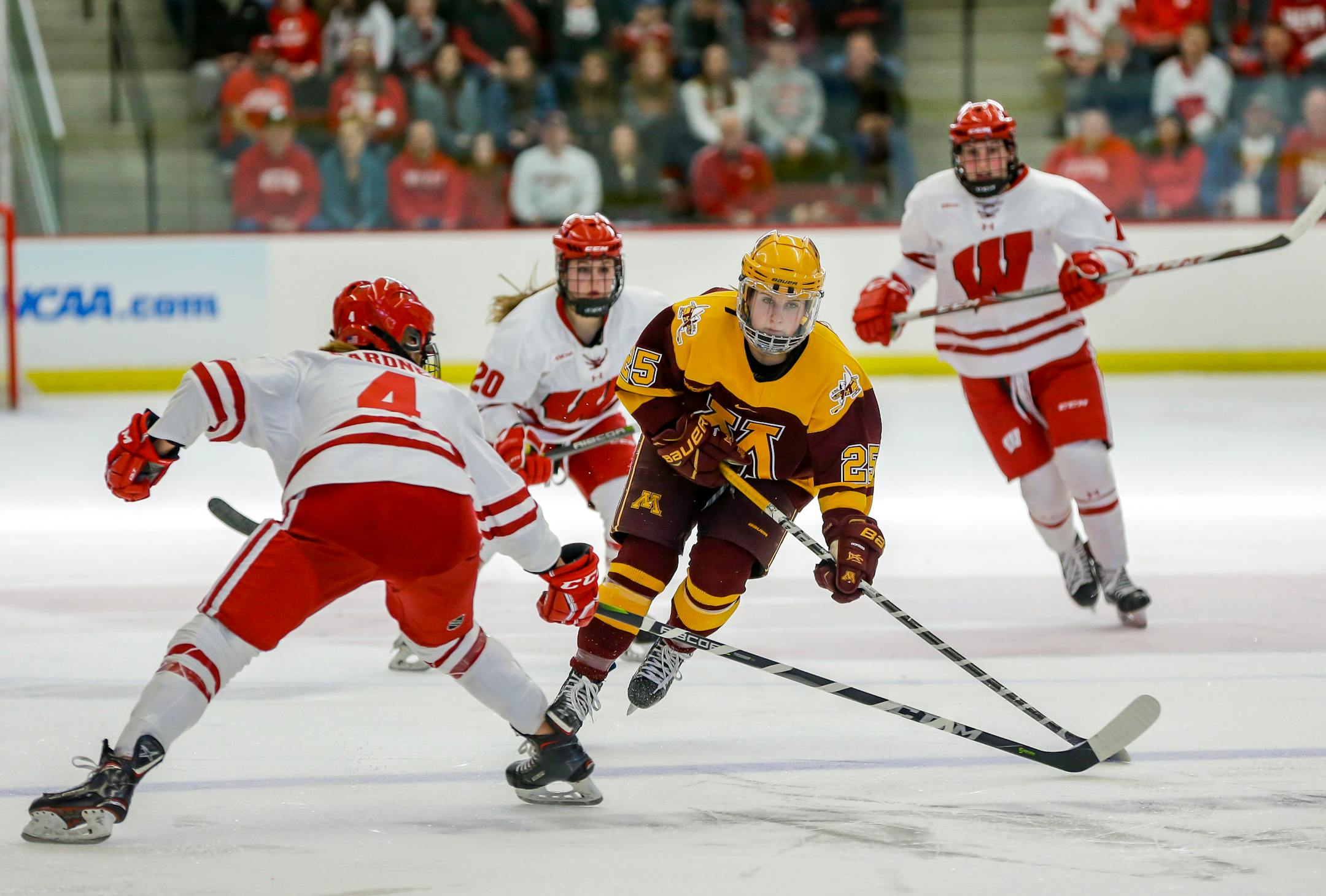 Minnesota's Nicole Schammel (25) drives against Wisconsin's Mikaela Gardner (4) during the second period of an NCAA Frozen Four quarterfinal March 10, 2018, in Madison, Wis. (Photo © Andy Manis) ORG XMIT: MIN1803101717487295