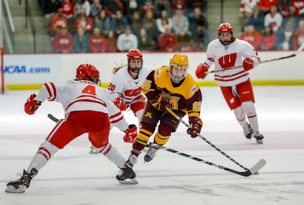 Minnesota's Nicole Schammel (25) drives against Wisconsin's Mikaela Gardner (4) during the second period of an NCAA Frozen Four quarterfinal March 10,