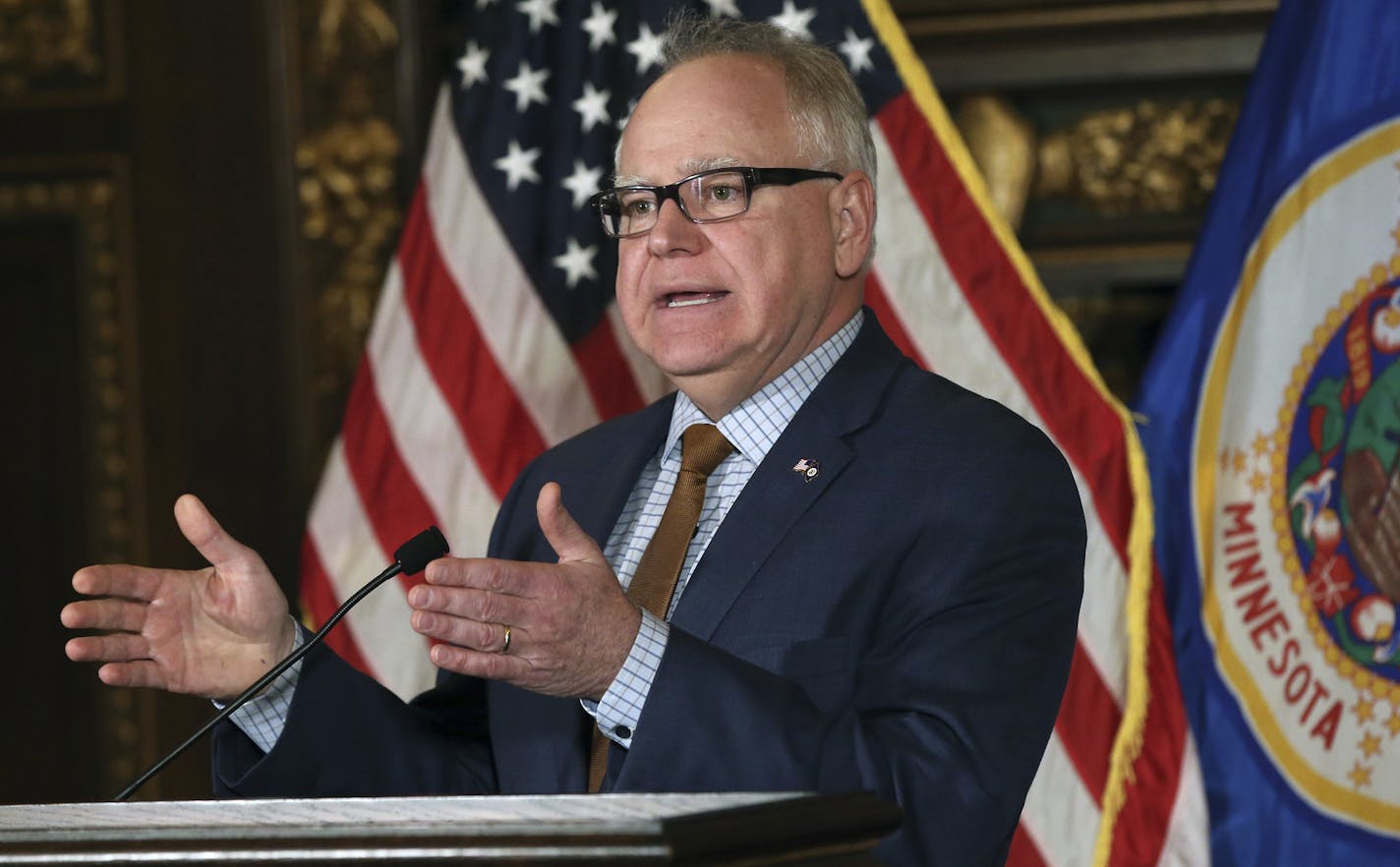 Minnesota Gov. Tim Walz addresses a news conference Tuesday, Feb. 5, 2019 in St. Paul, Minn. where he said a conference call with drug company executives has left him hopeful that the Legislature will pass a bill to address the opioid crisis that he can sign. (AP Photo/Jim Mone)