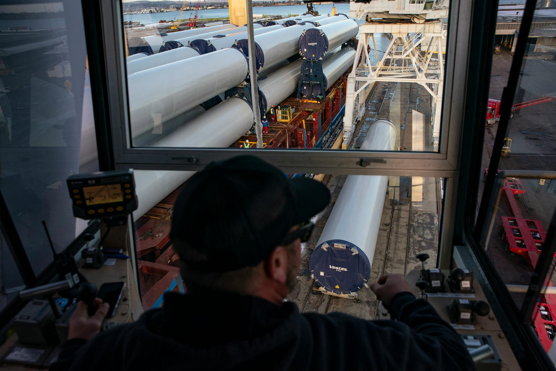 Keegan Beloy, a crane operator, worked in tandem with another crane to move a section of a wind turbine tower off the BBC Xingang and onto a flatbed truck.