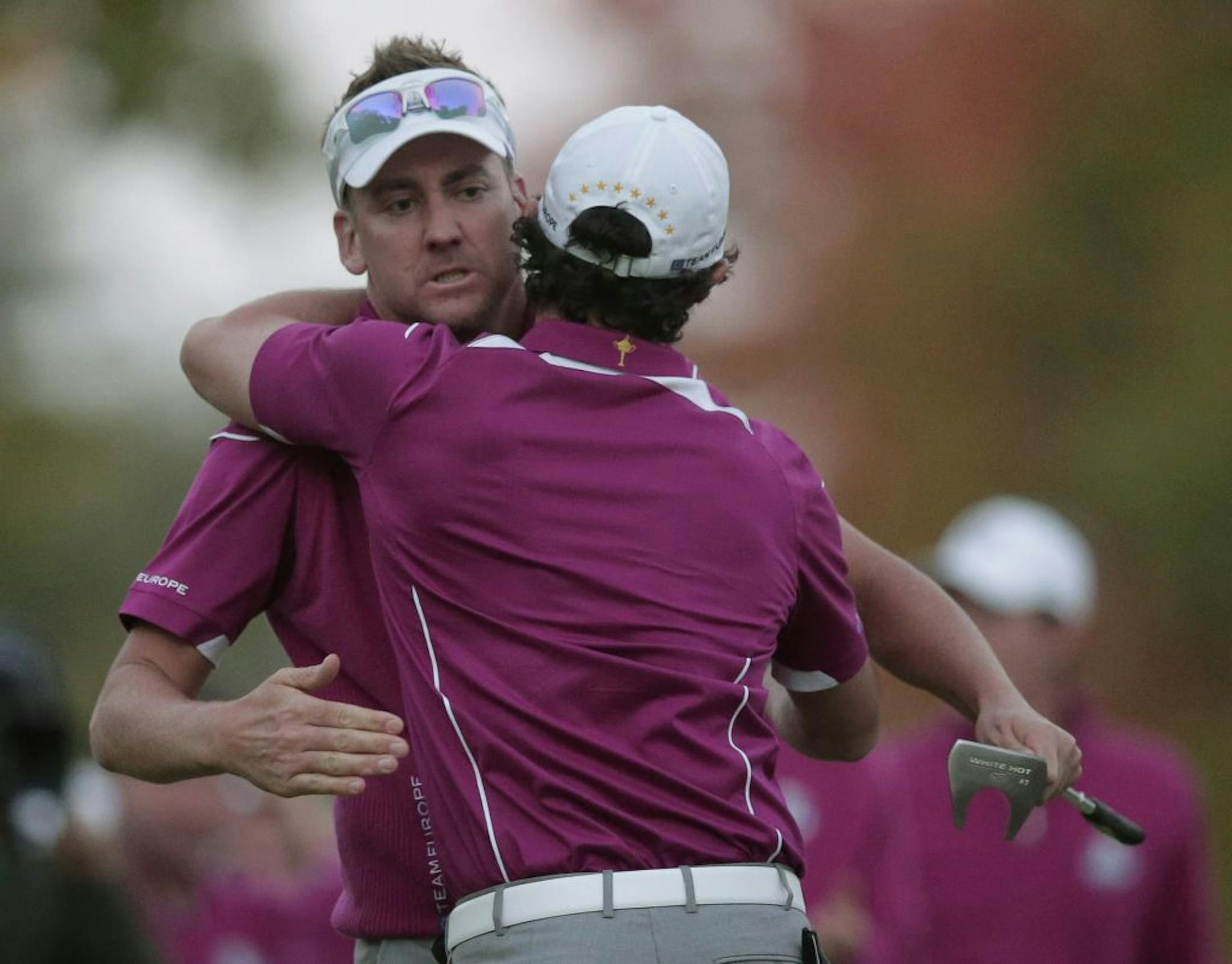 Europe's Ian Poulter hugs Rory McIlroy after winning their four-ball match at the Ryder Cup PGA golf tournament Saturday, Sept. 29, 2012, at the Medinah Country Club in Medinah, Ill.