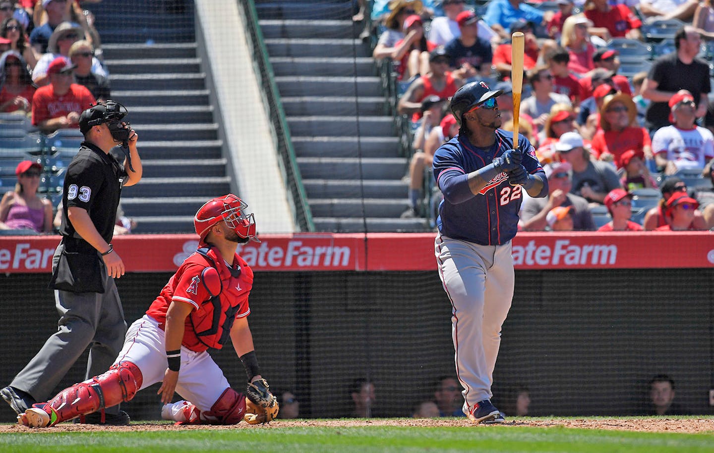 Minnesota Twins' Miguel Sano, right, hits a two-run home run as Los Angeles Angels catcher Juan Graterol, center, watches along with home plate umpire Will Little during the sixth inning of a baseball game, Sunday, June 4, 2017, in Anaheim, Calif.