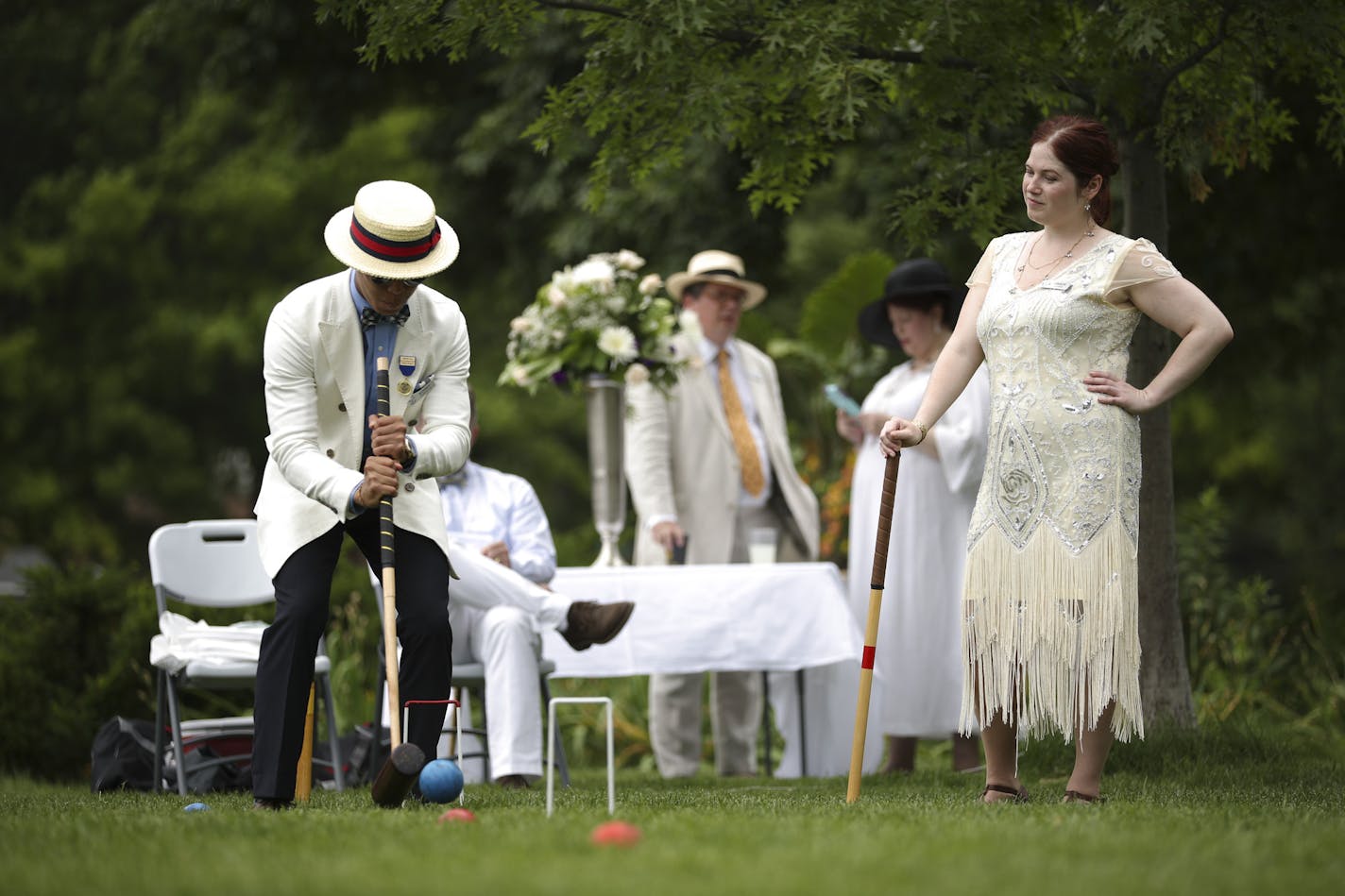 Sonny Sawansuk took his shot while Grace Schwab awaited her turn. ] JEFF WHEELER &#xef; jeff.wheeler@startribune.com The North Star Croquet Association kicked off its summer-long season in St. Paul with the Cheesebrough Cup, held at Summit Lookout Park. They be wore their best dressy whites while knocking the crap out of each others' balls Sunday afternoon, June 27, 2018 in what is becoming a sort of fancy Little League for adults with manners.