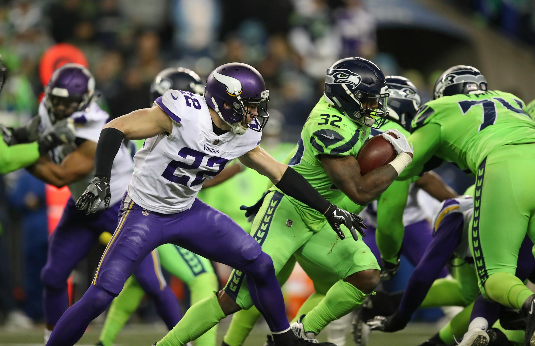 Seattle running back Chris Carson gained two yards on a fourth quarter run as Vikings free safety Harrison Smith turned to stop him.