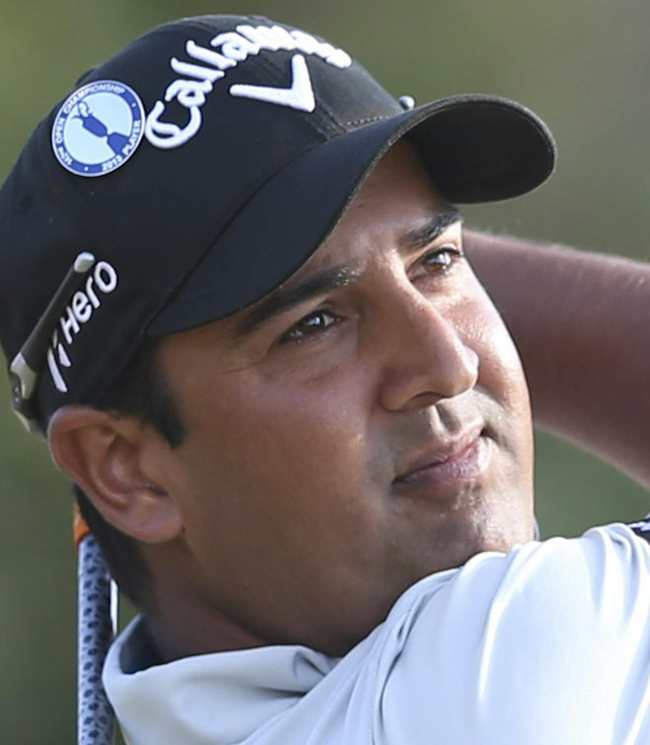 Shiv Kapur of India plays a shot off the 10th tee during the first round of the British Open Golf Championship at Muirfield, Scotland, Thursday July 18, 2013. (AP Photo/Scott Heppell)