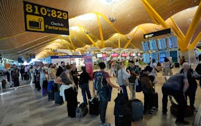 Passengers queue at Madrid airport, during a major power outage, Monday, April 28, 2025.