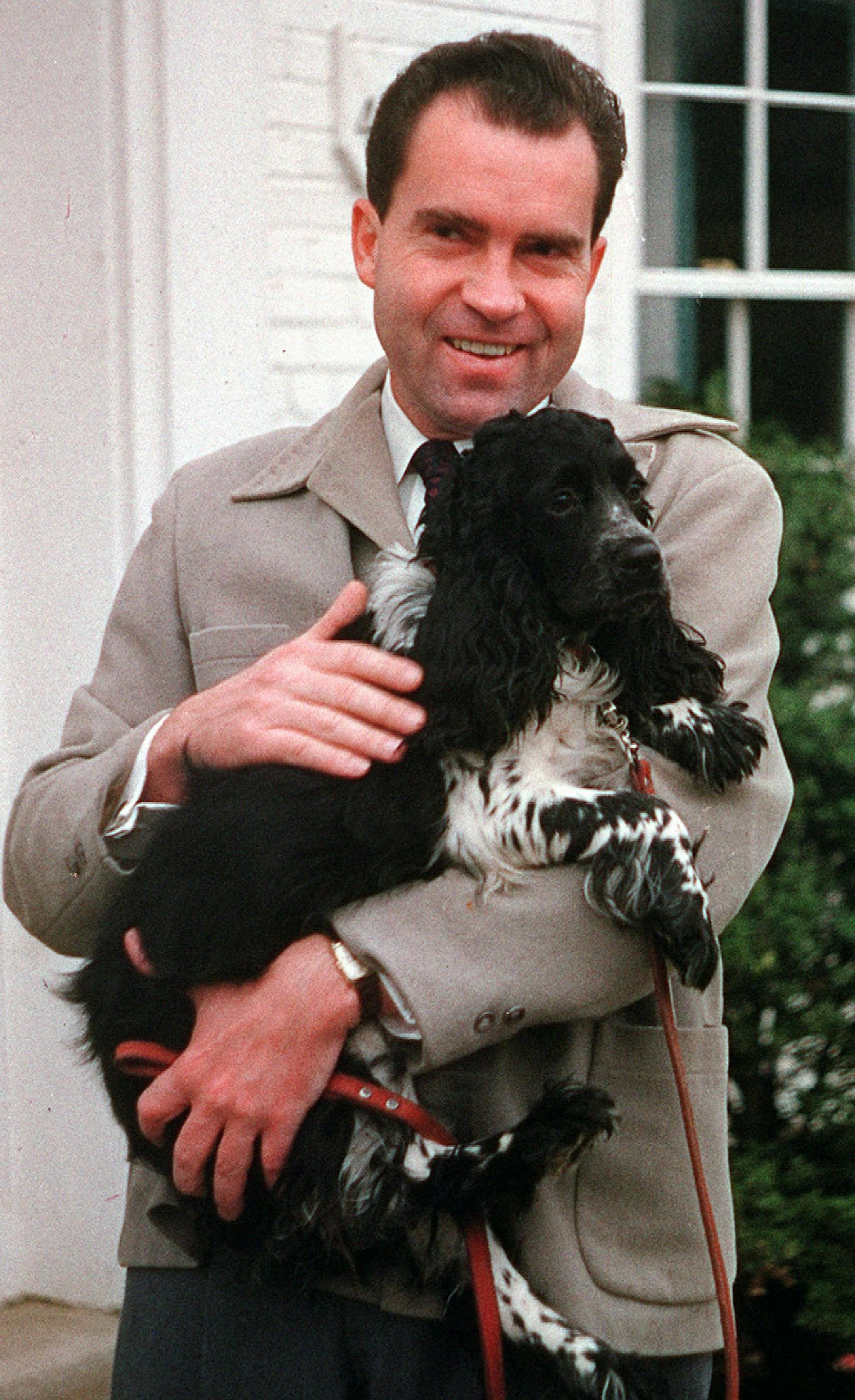 Richard Nixon is seen with his dog "Checkers."