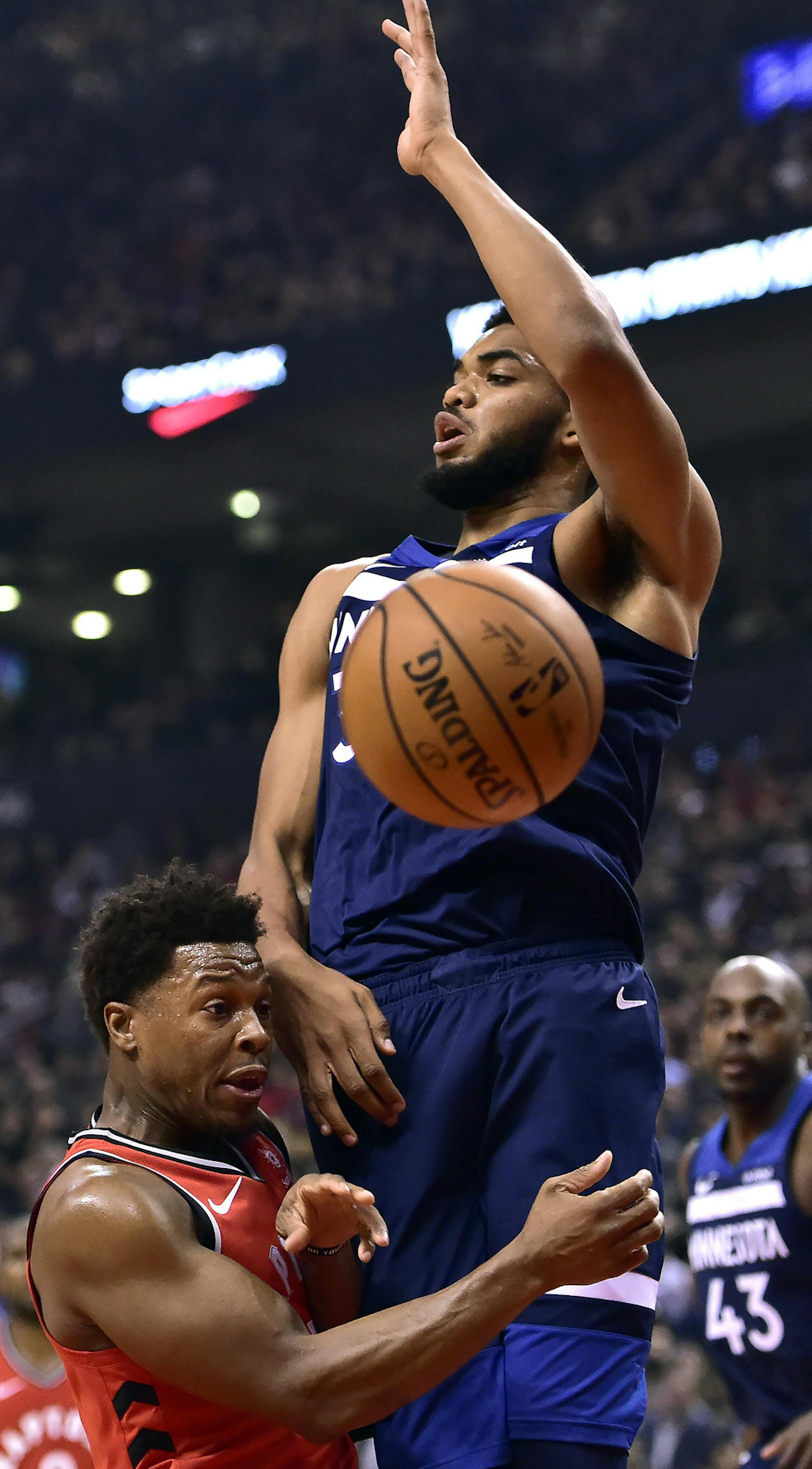Toronto Raptors guard Kyle Lowry (7) collides with Minnesota Timberwolves forward Karl-Anthony Towns (32) during the first half of an NBA basketball game, Wednesday, Oct. 24, 2018, in Toronto. (Frank Gunn/The Canadian Press via AP)