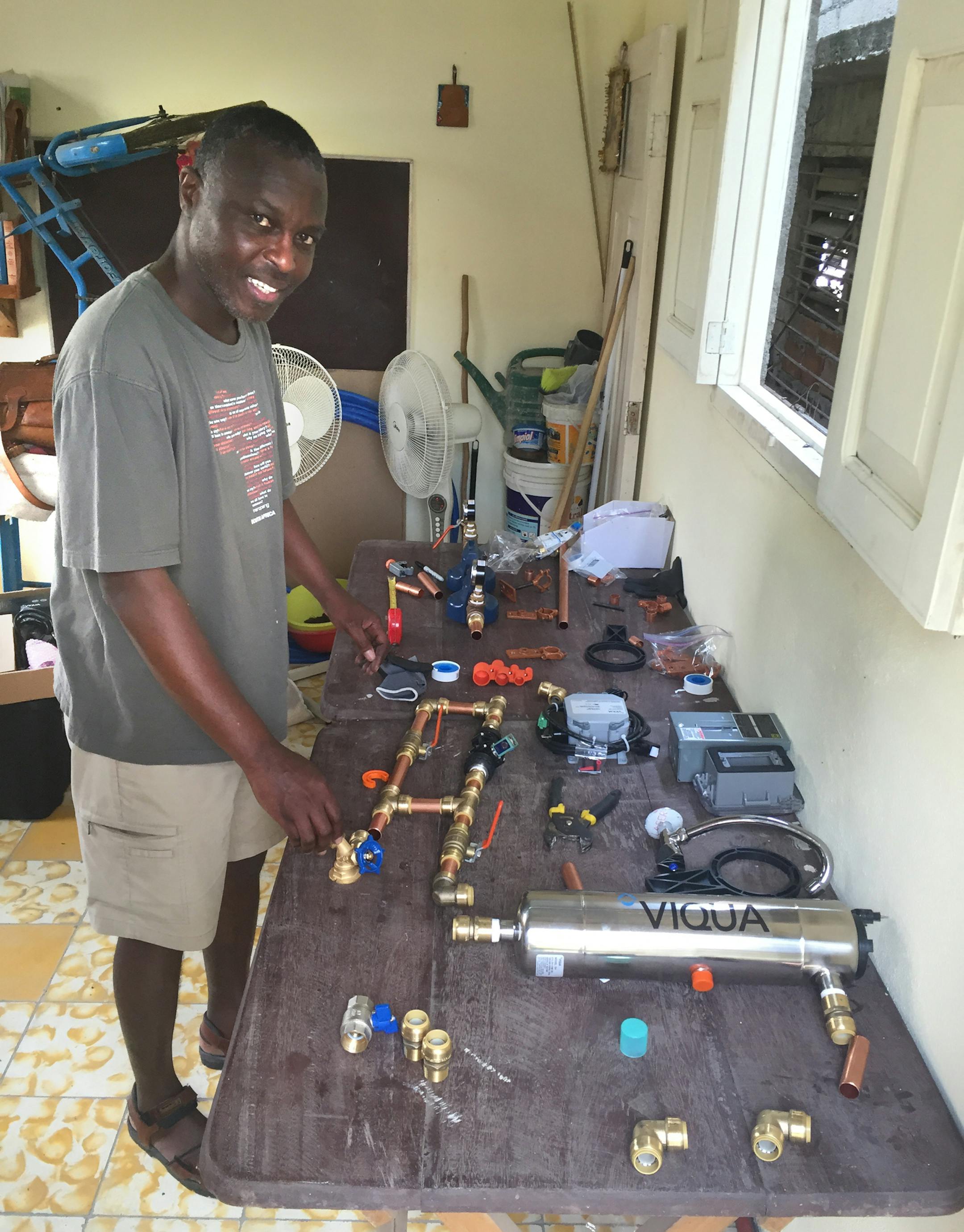 Laying out the parts and pieces of the system. We start with this to make sure we have all the parts and to confirm the system fits in the allocated space. We then put the parts together by screwing and tightening to avoid any leaks. We do this in sections before installing them on the stained wood backboard We had this set up in the sacristy of the church. Le Iglesia Episcopal San Juan Bautista, In Palma Soriano. photos provided by Hector Nanka Bruce