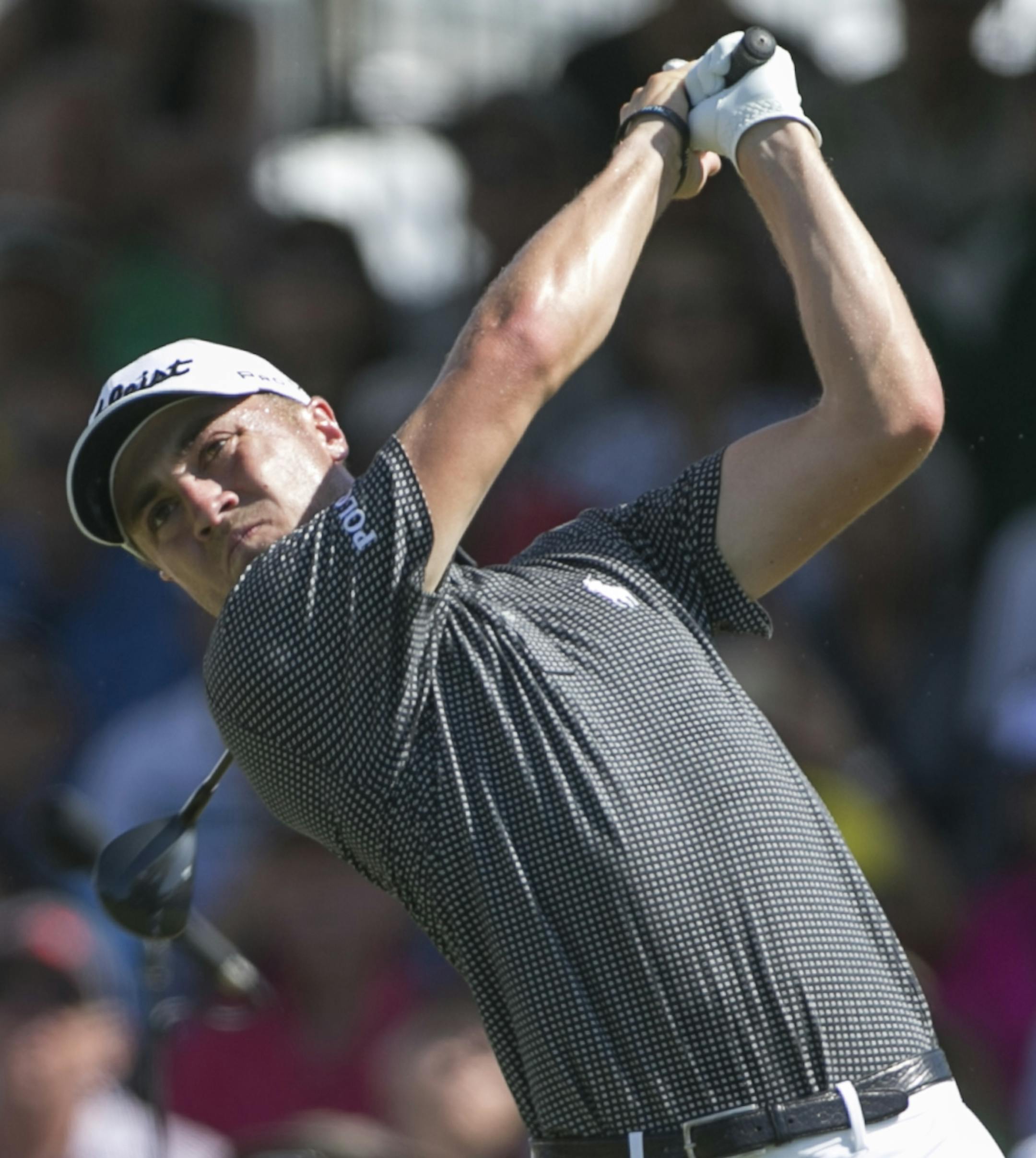 Justin Thomas drives on the first tee during the final round of the Sony Open golf tournament, Sunday, Jan. 15, 2017, in Honolulu. (AP Photo/Marco Garcia)