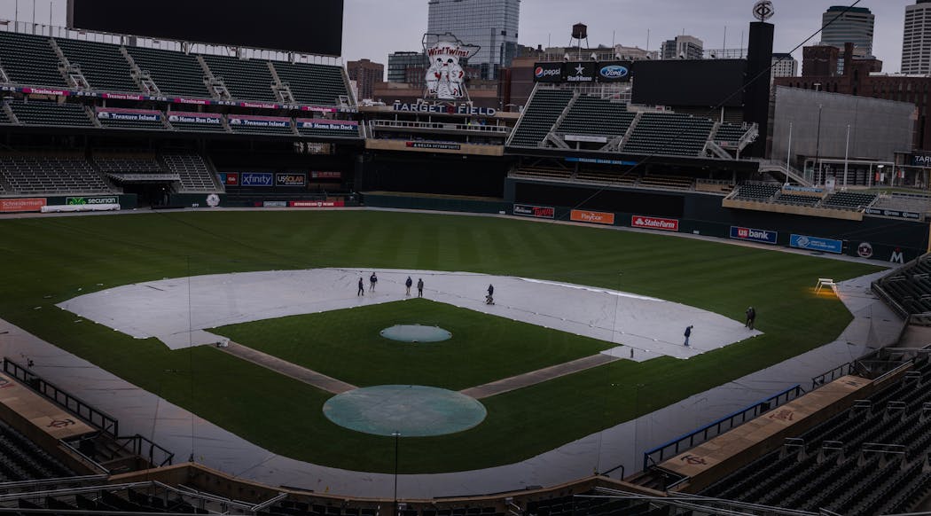 In late March, grounds workers prepare for the Twins home opener at Target Field.