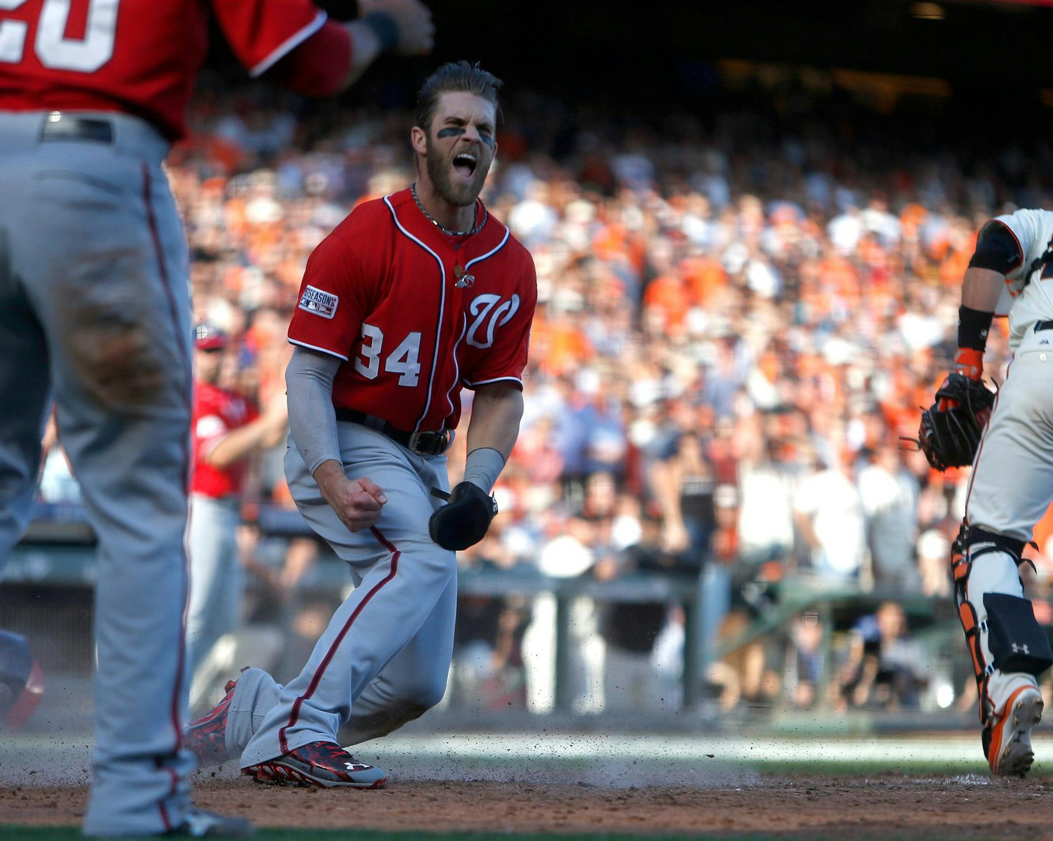 Washington Nationals' Bryce Harper (34) celebrates his run after scoring off of a throwing error by San Francisco Giants starting pitcher Madison Bumgarner (40) during the seventh inning of Game 3 of the National League Division Series on Monday, Oct. 6, 2014, at AT&T Park in San Francisco. (Nhat V. Meyer/Bay Area News Group/MCT)