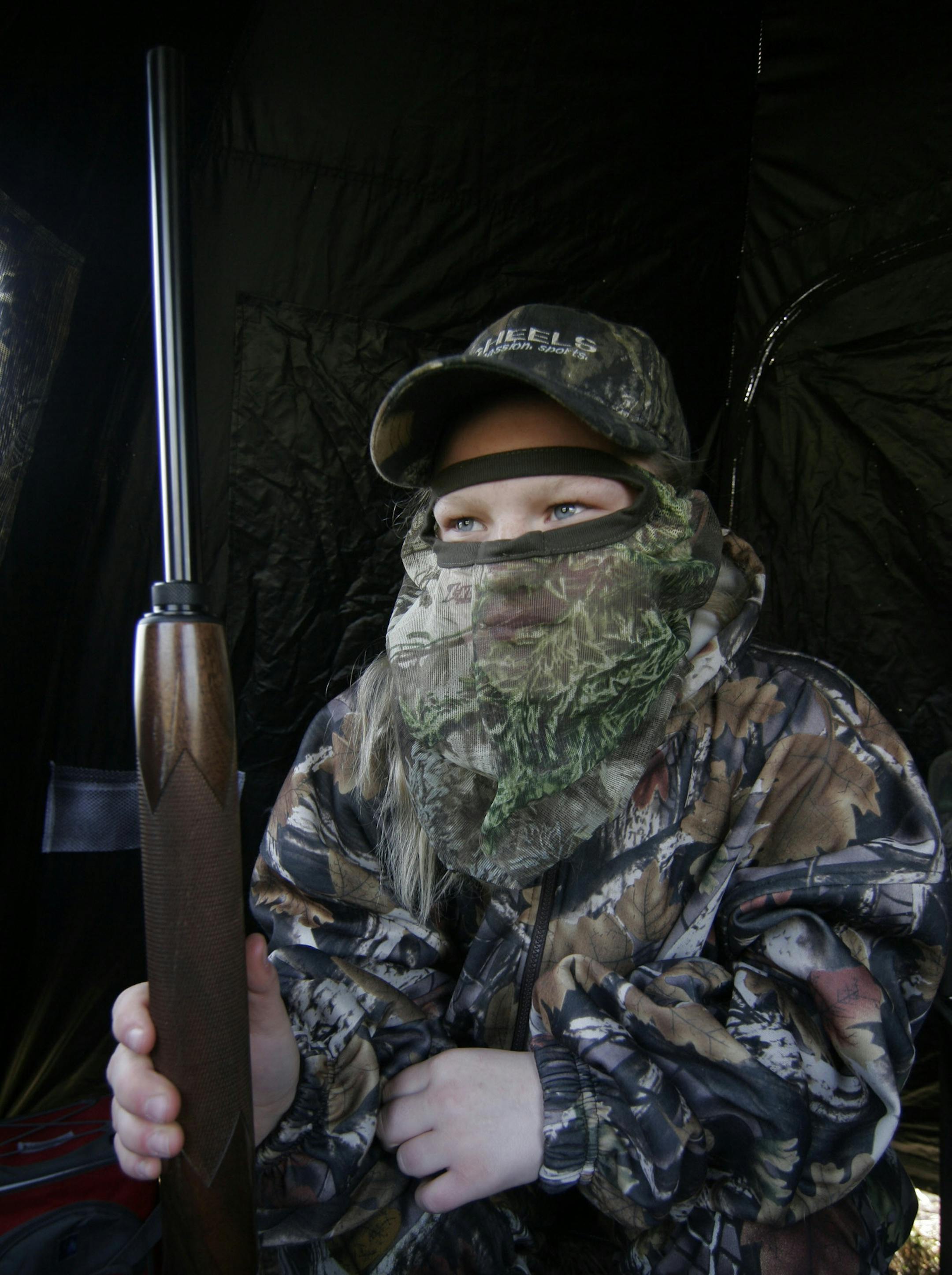 Lorna Wright, 13, of Vernon Center, Minn., watched for turkeys from her hunting blind during Minnesota's youth turkey hunt last weekend.
