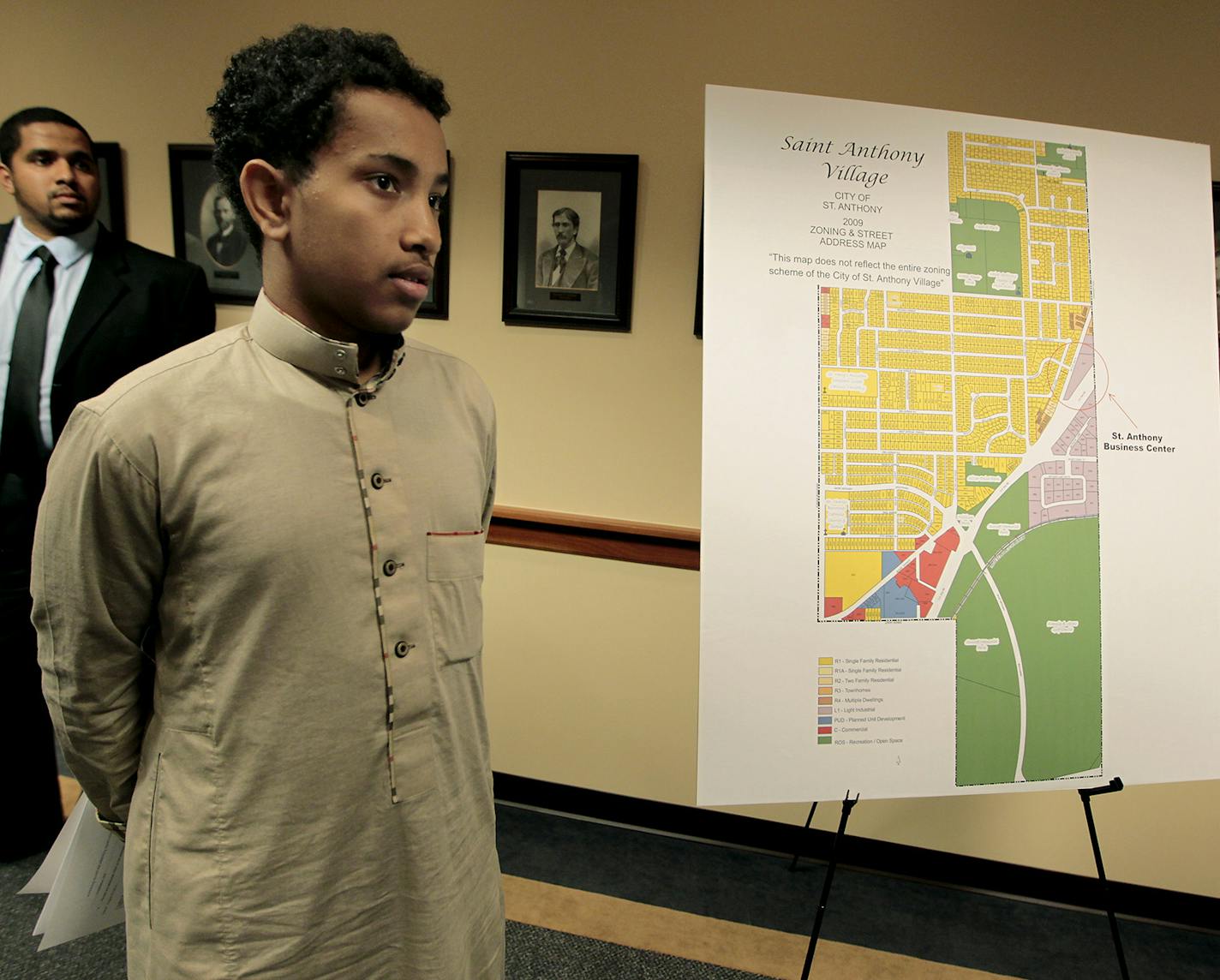 Abdullahi Mohamed, 15, stood next to one of the land renderings available after United States Attorney Andrew M. Luger announced the filing of a lawsuit against the City of St. Anthony Village for an alleged violation of the Religious Land Use and Institutionalized Persons Act of 2000, during a press conference at the United State Attorney's Office, Wednesday, August 27, 2014 in Minneapolis, MN. ] (ELIZABETH FLORES/STAR TRIBUNE) ELIZABETH FLORES &#x2022; eflores@startribune.com