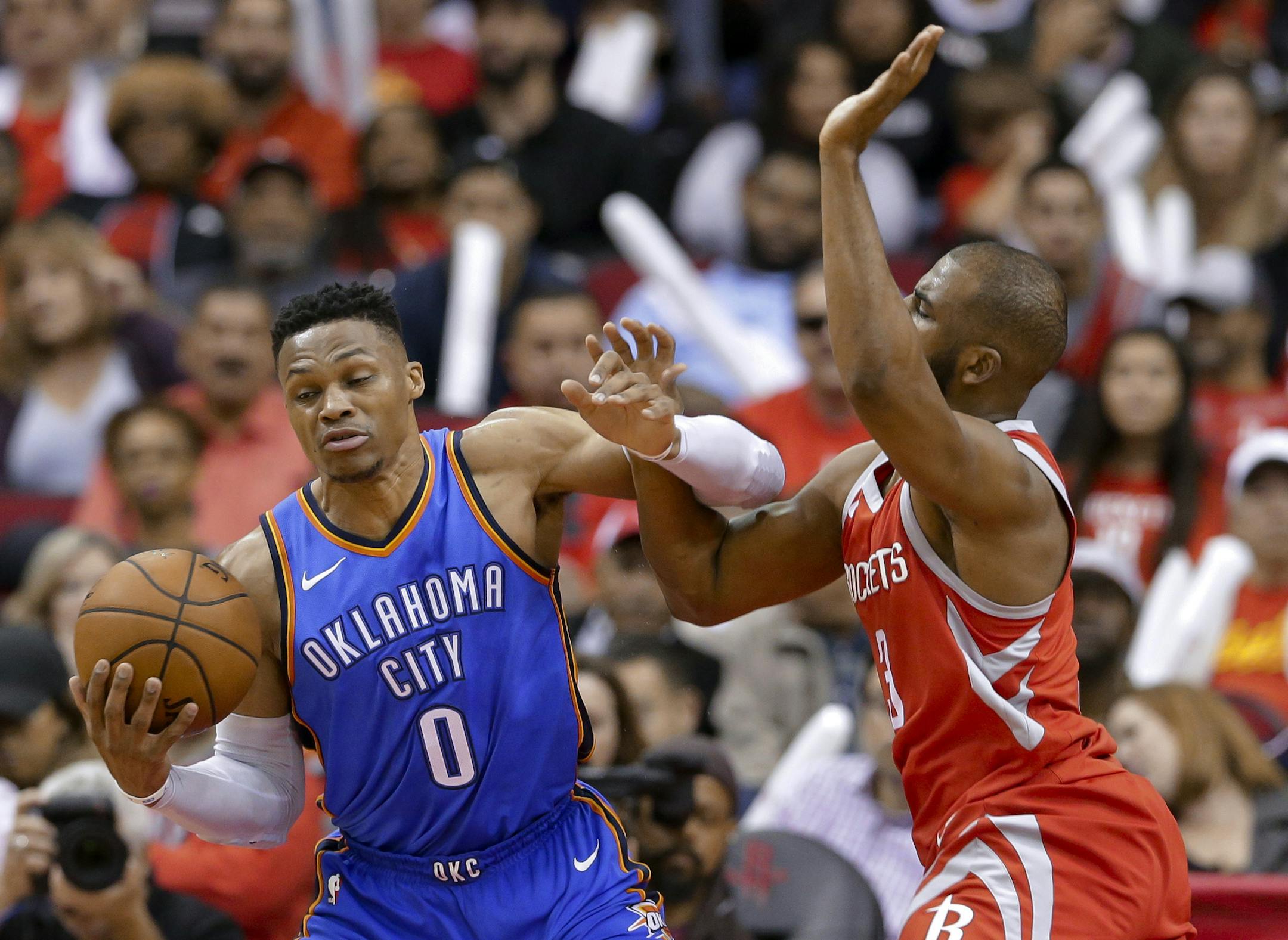 Oklahoma City Thunder guard Russell Westbrook (0) is fouled by Houston Rockets guard Chris Paul (3) during the second half of an NBA basketball game Saturday, April 7, 2018, in Houston. (AP Photo/Michael Wyke) ORG XMIT: TXMW107