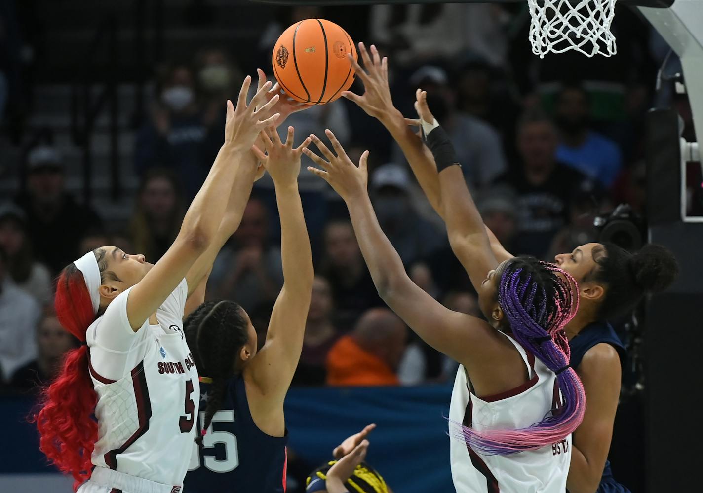 South Carolina forward Victaria Saxton (5), UConn guard Azzi Fudd (35), South Carolina forward Aliyah Boston (4) and UConn forward Olivia Nelson-Ododa (20) fight for a rebound in the first quarter during the championship game in the NCAA Women's Final Four on Sunday, April 3, 2022 at Target Center in Minneapolis. ] AARON LAVINSKY• Aaron.lavinsky@startribune.com