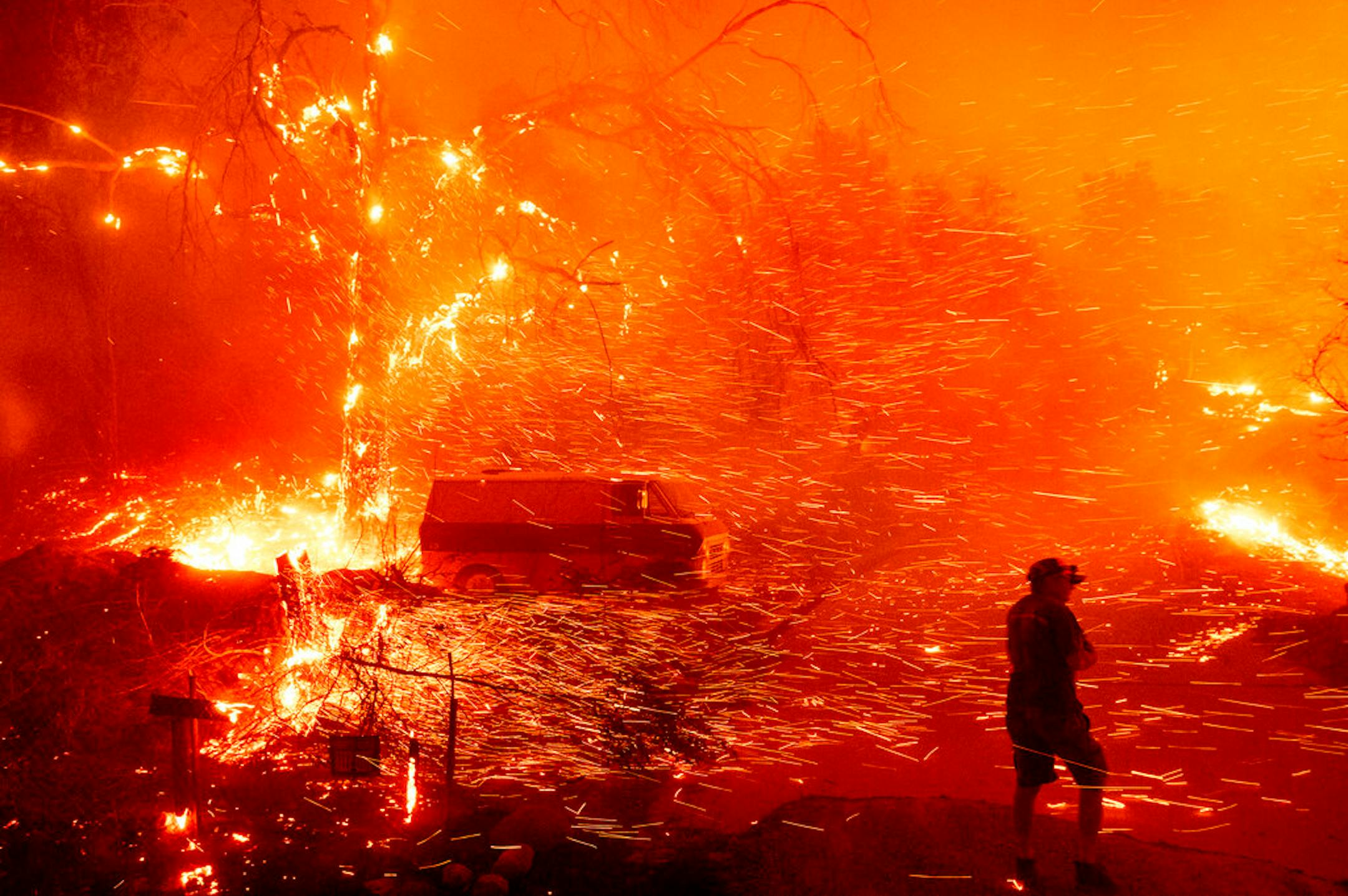 Bruce McDougal prepares to defend his home as the Bond Fire burns though the Silverado community in Orange County, Calif., on Thursday, Dec. 3, 2020. (AP Photo/Noah Berger)
