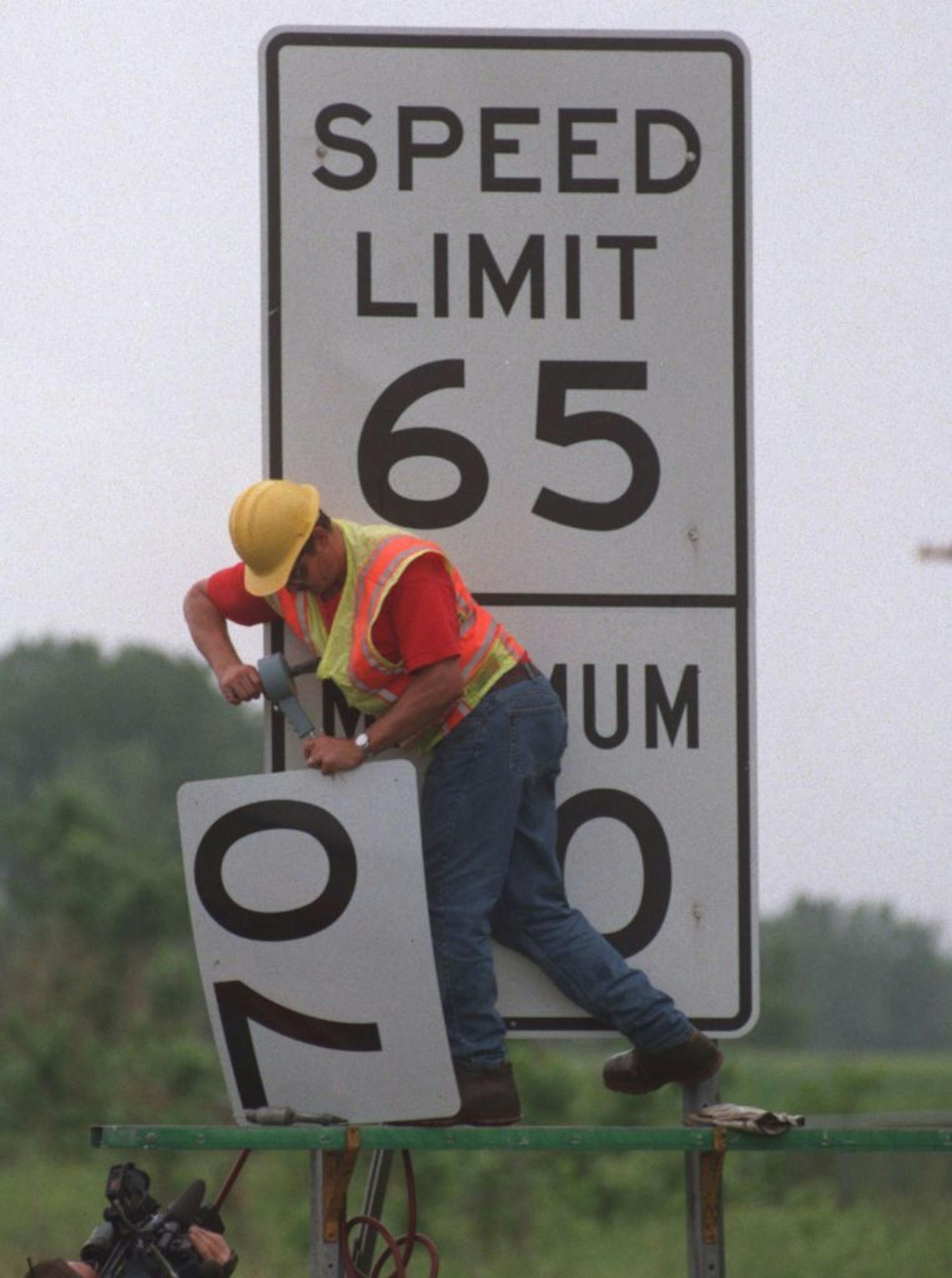 -- Minnesota Transportation Department worker Myron Hennen changes a speed limit sign from 65 mph to 70 mph along HWY 35 in Forest Lake....