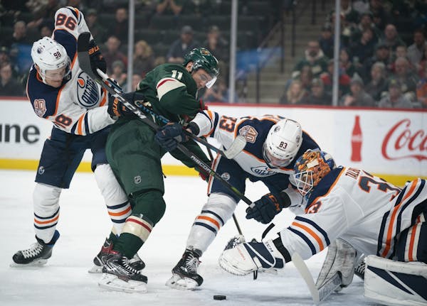 Edmonton Oilers goaltender Cam Talbot (33) reached for the puck in front of him in the first period while the Oilers defenseman Matt Benning (83) and 