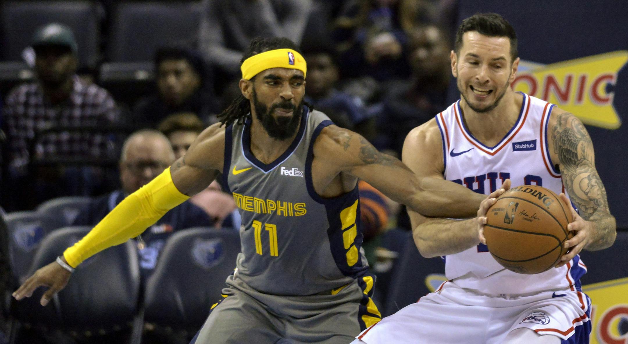 Memphis Grizzlies guard Mike Conley (11) and Philadelphia 76ers guard JJ Redick struggle for control of the ball in the second half of an NBA basketball game Saturday, Nov. 10, 2018, in Memphis, Tenn. (AP Photo/Brandon Dill)
