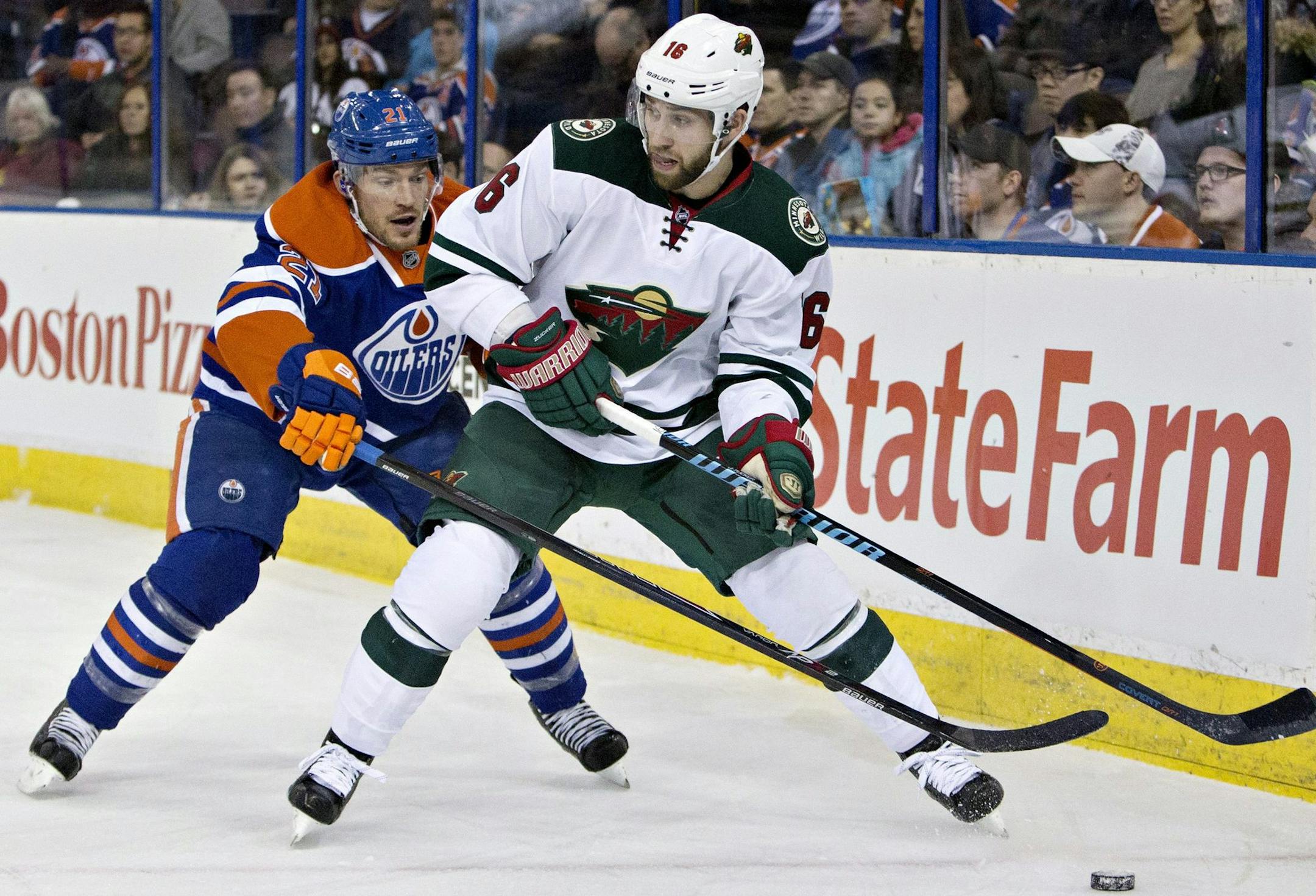 Minnesota Wild's Jason Zucker (16) is chased by Edmonton Oilers' Andrew Ference (21) during first period NHL hockey action in Edmonton, Alberta, on Tuesday Jan. 27, 2015. (AP Photo/The Canadian Press, Jason Franson)