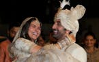 Bollywood actors Alia Bhatt and Ranbir Kapoor pose for photographs after their wedding outside their residence in Mumbai, India, Thursday, April 14, 2