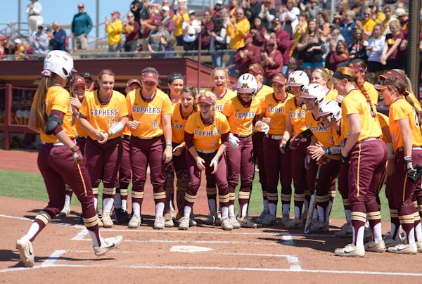 Teammates celebrated with Minnesota infielder Makenna Partain (3) after Partain's grand slam in the bottom of the first inning against Wisconsin.