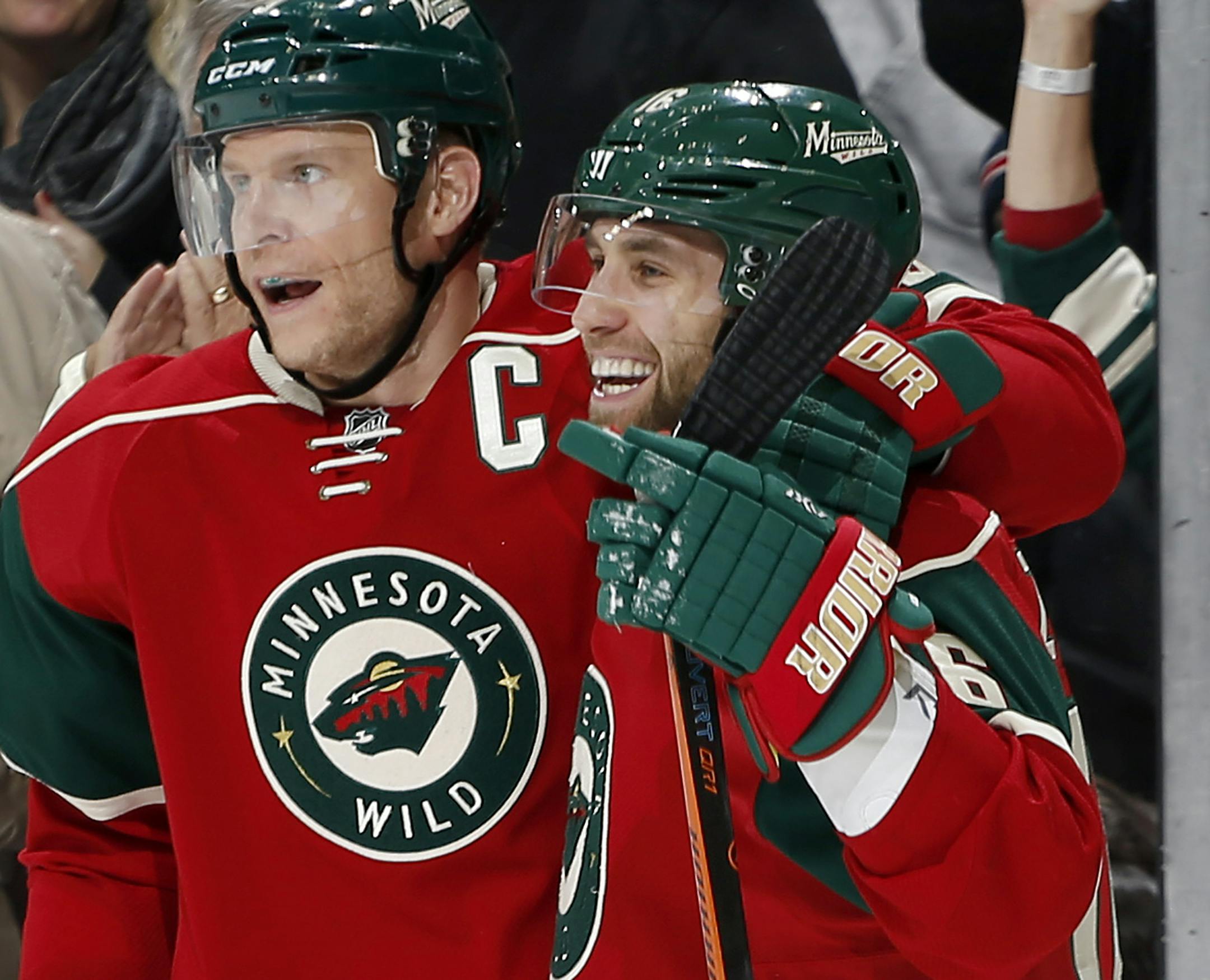 Mikko Koivu (9) and Jason Zucker (16) celebrated a goal by Zucker in the first period.